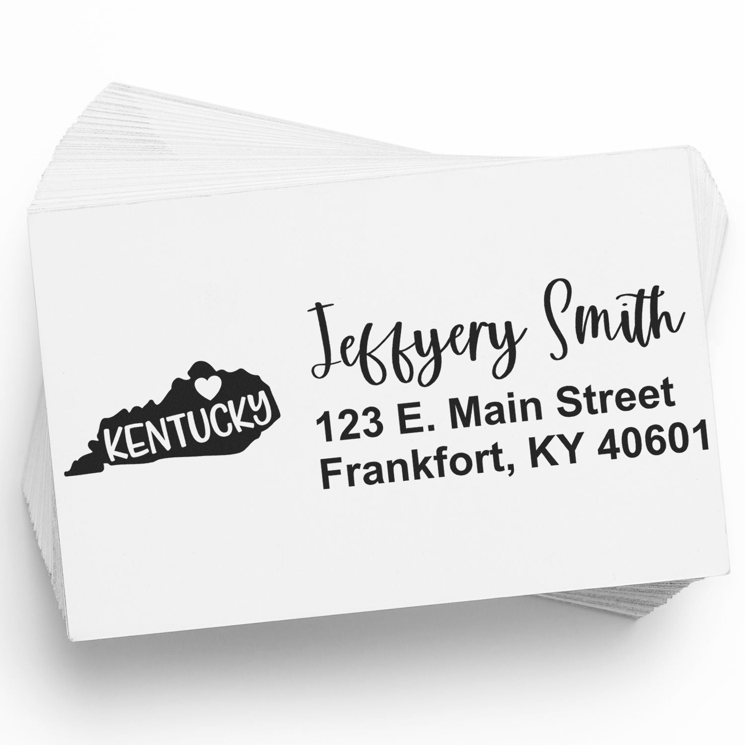 Stack of envelopes stamped with the PSI Pre-Inked Kentucky State Love Customized Address Stamp, featuring a heart and Kentucky silhouette, personalized with a name and address in black ink.