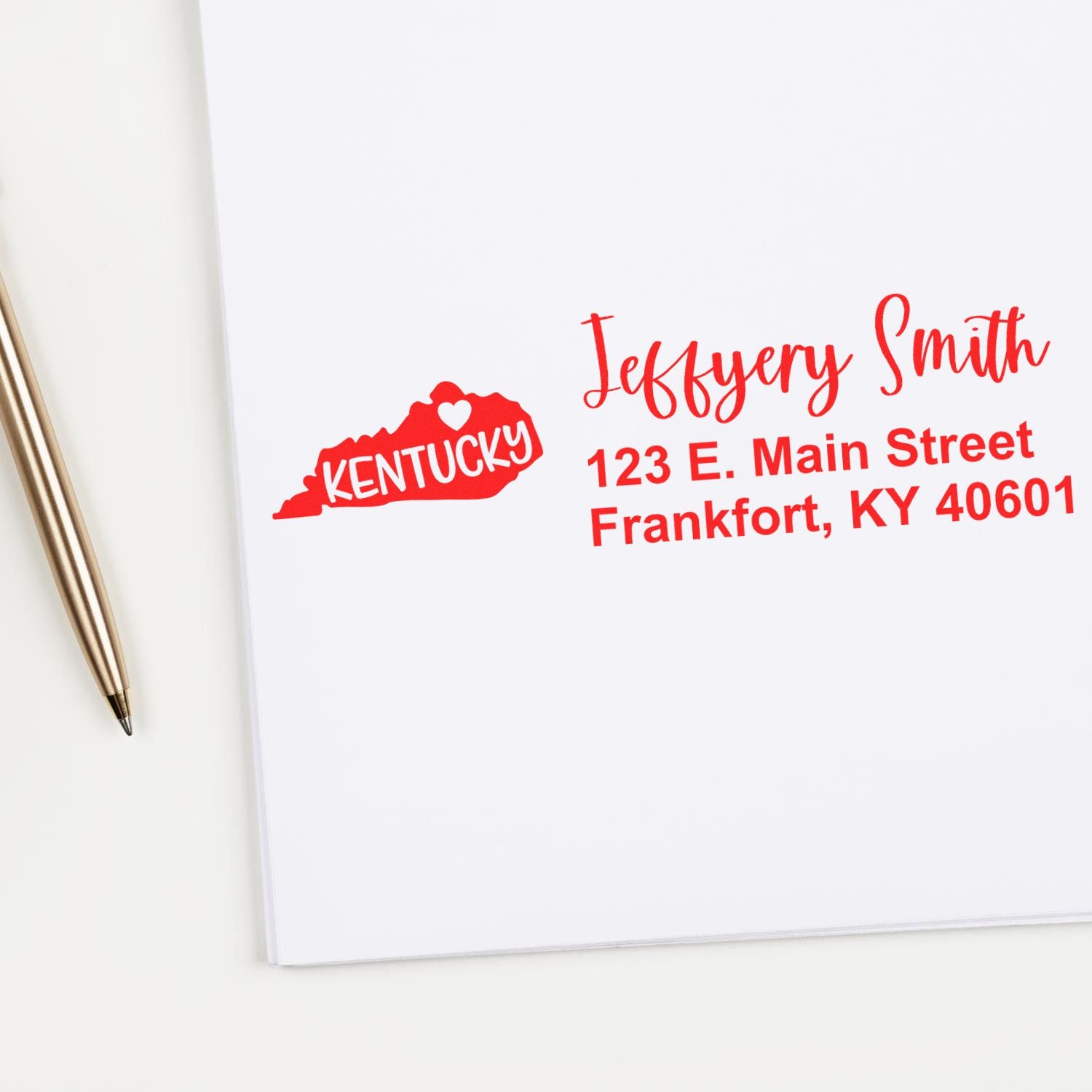 PSI Pre-Inked Kentucky State Love Customized Address Stamp in red ink on white paper, featuring a Kentucky state outline with a heart and personalized address next to a gold pen.