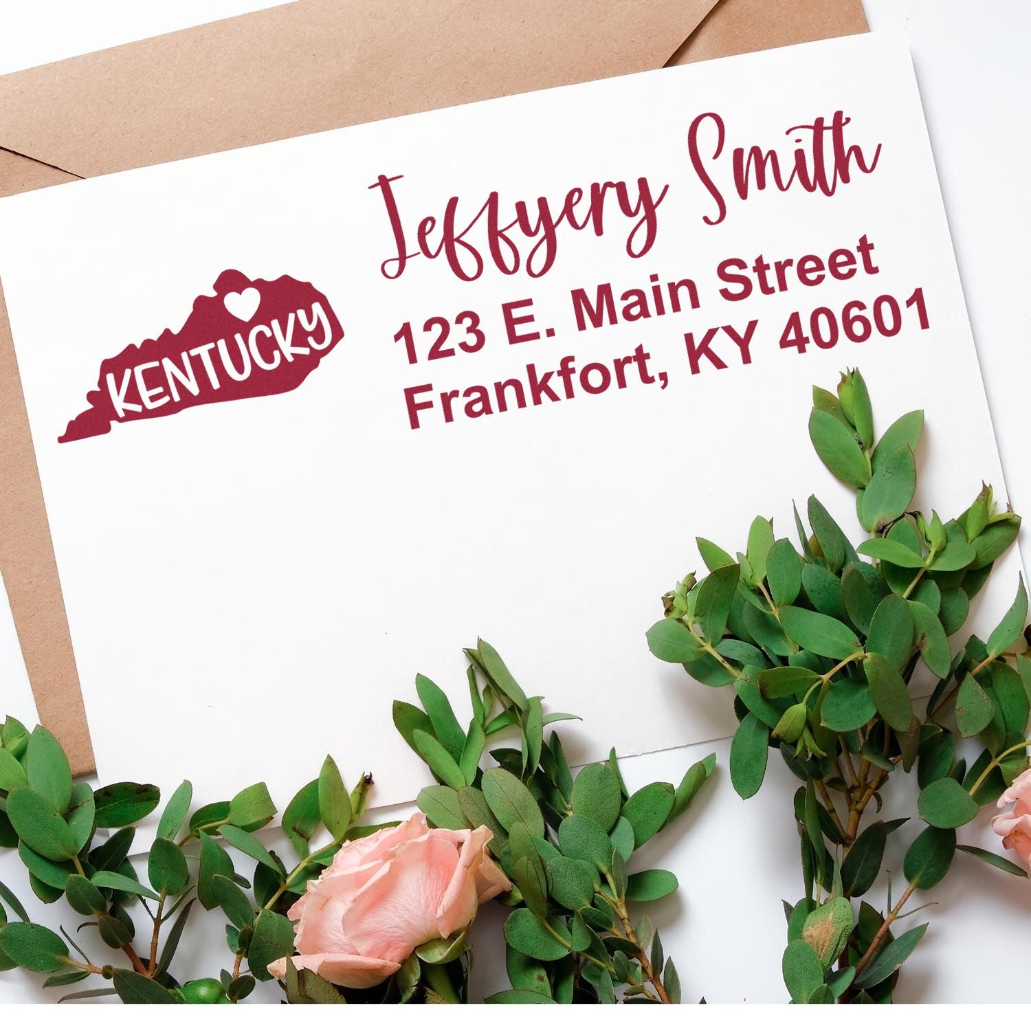 Kentucky State Love Personalized Address Stamp on an envelope with greenery and pink roses, featuring a heart design and address in red text.