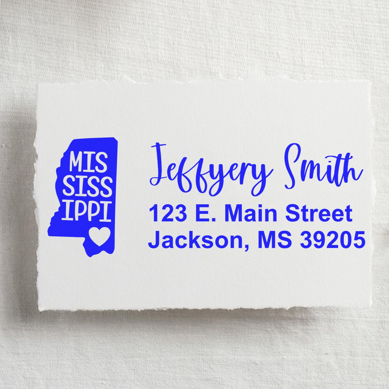 PSI Pre-Inked Mississippi State Love Customized Address Stamp on white paper, featuring a blue state outline with heart, personalized with name and address in elegant font.