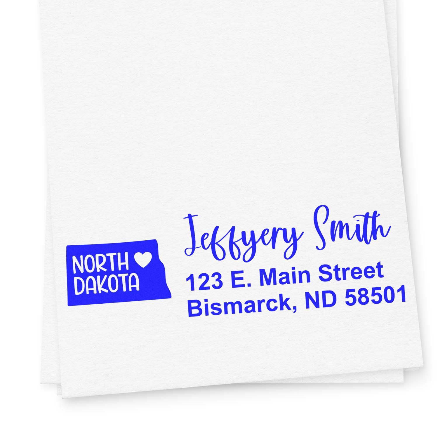 PSI Pre-Inked North Dakota State Love Customized Address Stamp on white paper, featuring a blue state outline with a heart and personalized address details in elegant font.