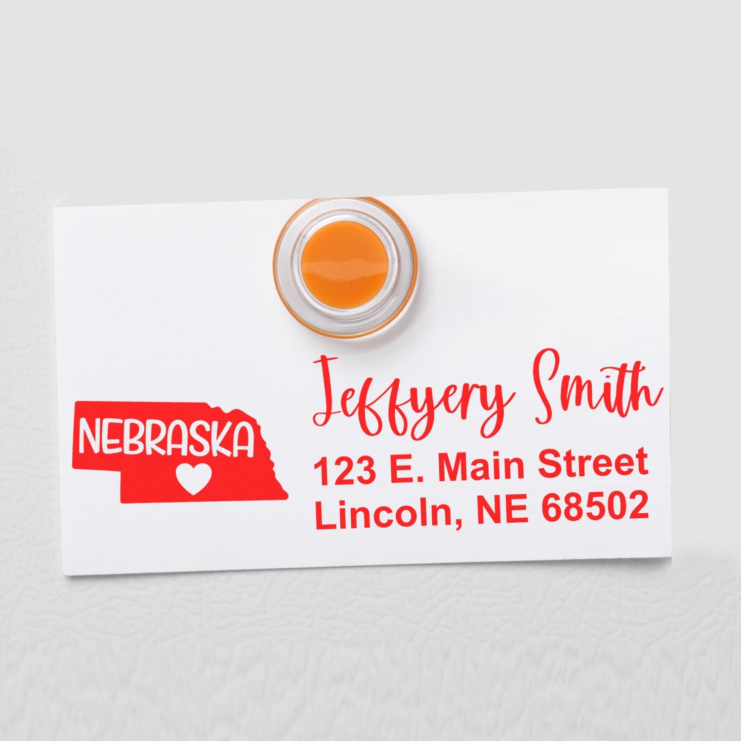 PSI Pre-Inked Nebraska State Love Customized Address Stamp on white card with red text, featuring Nebraska outline and heart. Displays name, street, city, and zip code in bold, stylish font.