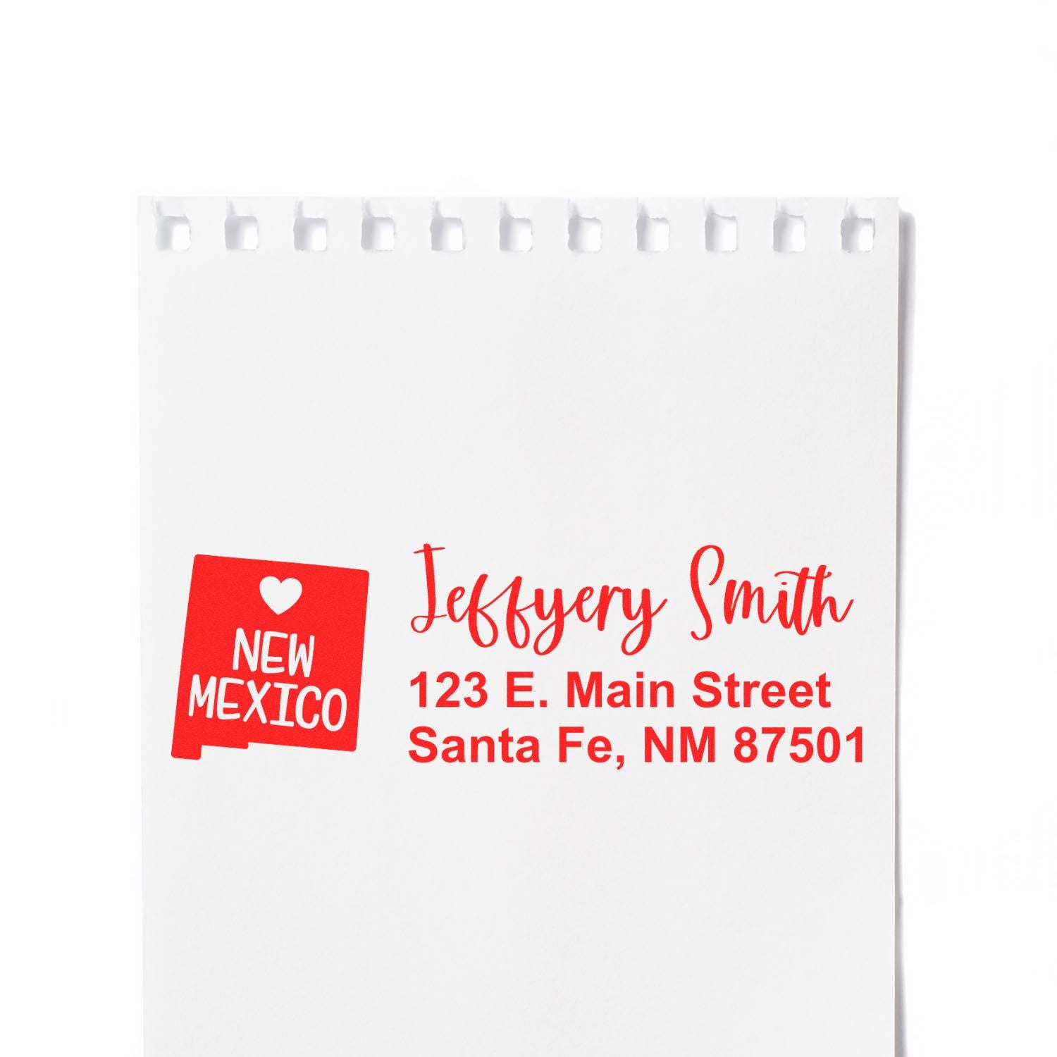 Slim New Mexico Custom Address Stamp for Envelopes displayed on white paper, featuring a red design with a heart and state outline, personalized with name and address in bold, stylish font.