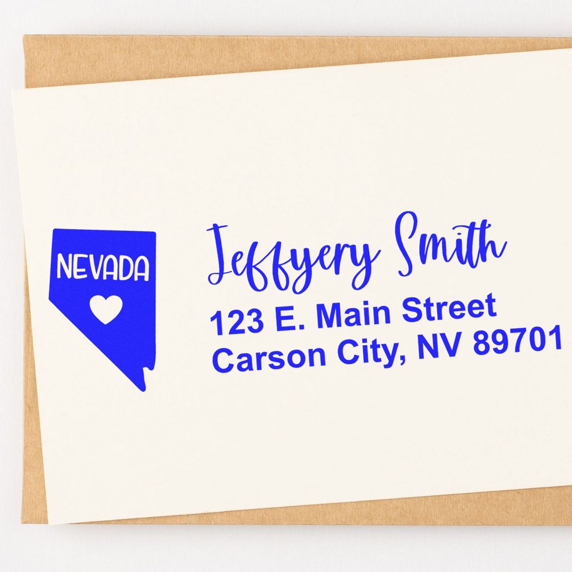 Nevada State Love Personalized Address Stamp on an envelope, featuring a blue Nevada state outline with a heart and custom address text in blue.