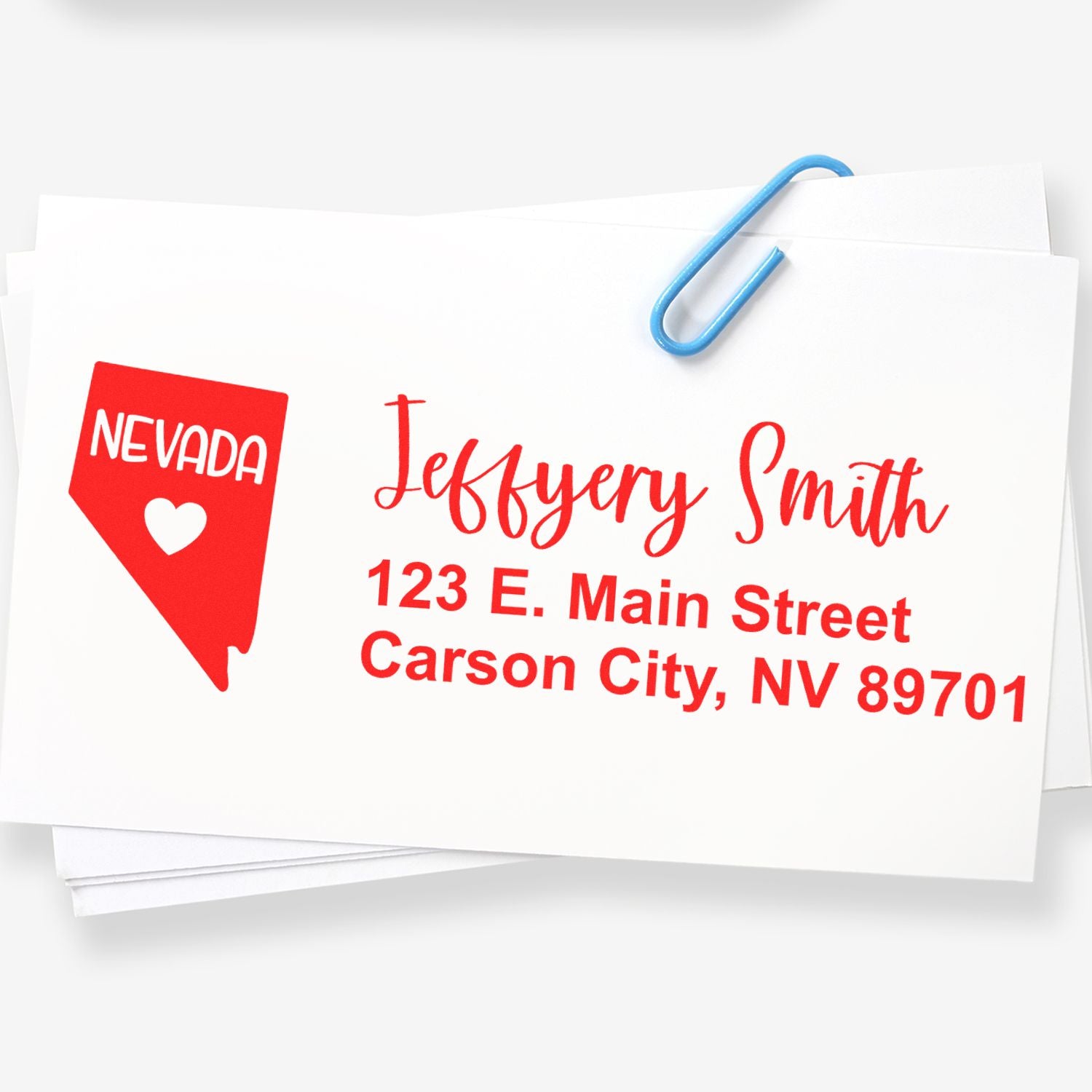 PSI Pre-Inked Nevada State Love Customized Address Stamp on white paper, featuring a red Nevada state outline with a heart and red text for a personalized address.