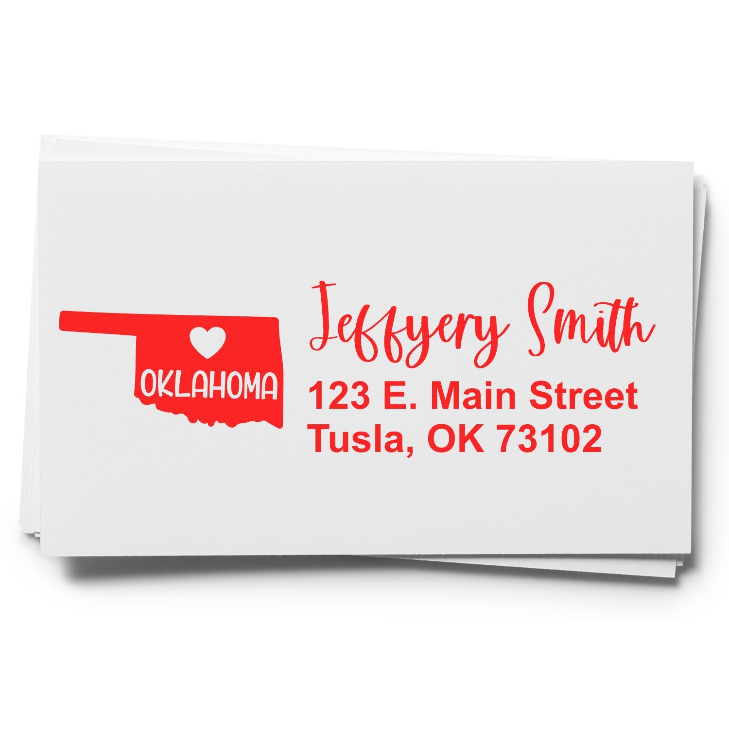 Image of a personalized address stamp featuring the outline of Oklahoma with a heart. Text reads Jeffery Smith, 123 E. Main Street, Tusla, OK 73102 in red. Product: Oklahoma State Love Personalized Address Stamp.