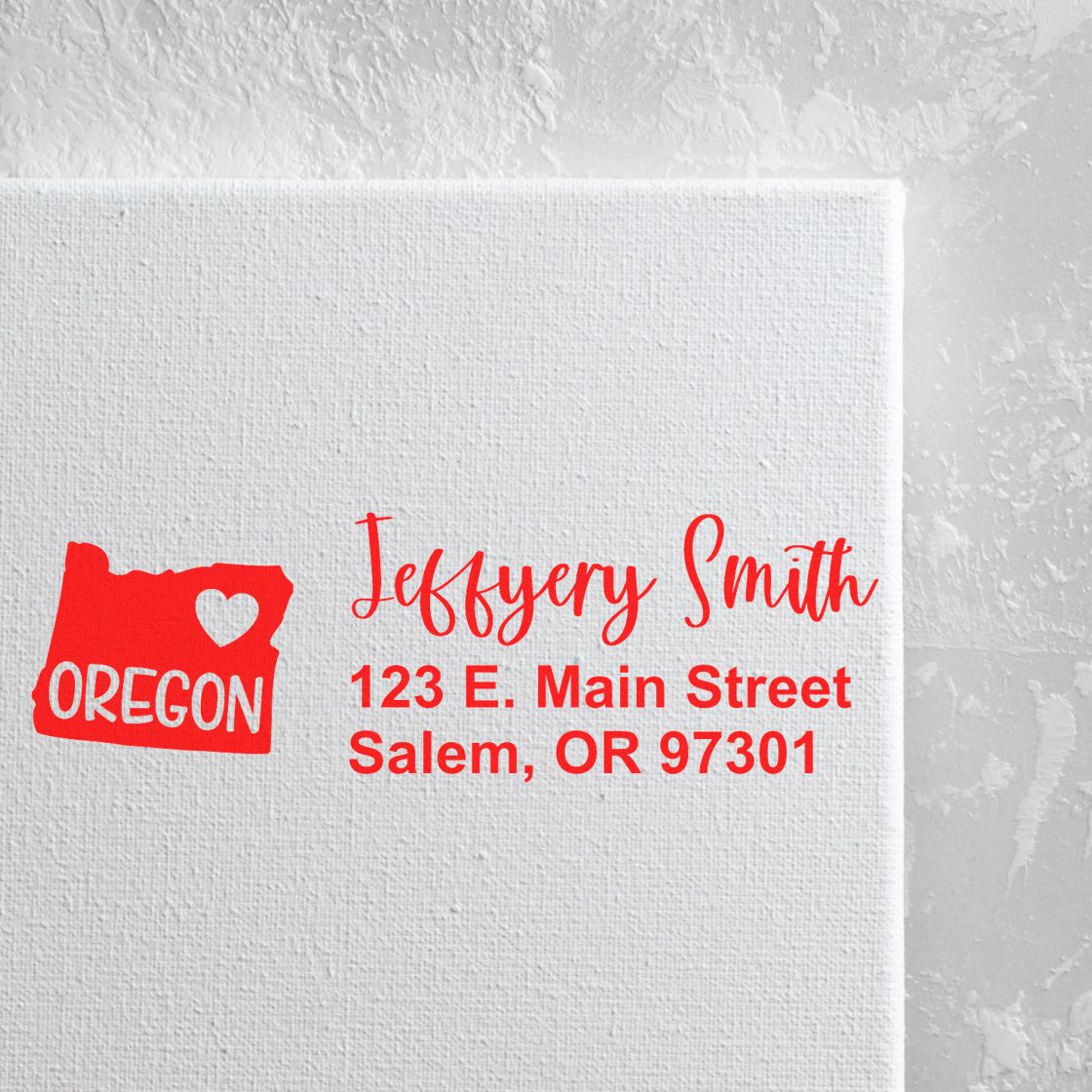 Oregon State Love Personalized Address Stamp in red ink on white canvas, featuring a heart and state outline with sample address: Jeffery Smith, 123 E. Main Street, Salem, OR 97301.