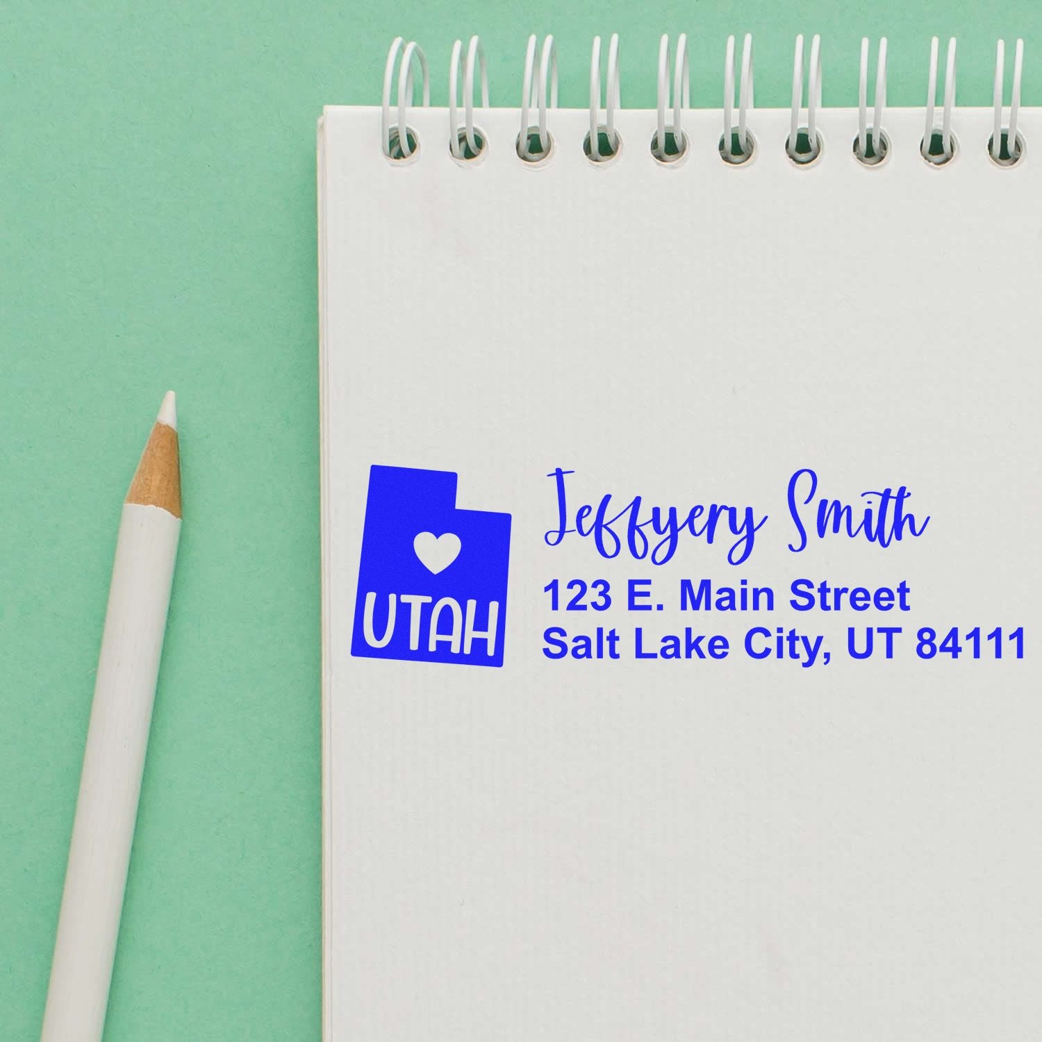 Utah State Love Personalized Address Stamp on a notepad with a pencil. Features a blue Utah state outline with a heart, and sample address text in blue. Perfect for adding a personal touch to mail.