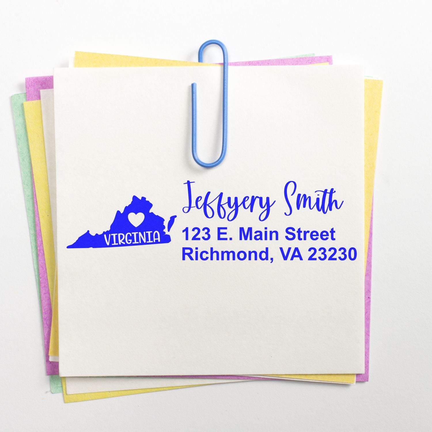 State Love of Virginia Custom Address Stamp Self-Inking on a white card with blue text, featuring a Virginia map and heart design. The card is clipped to pastel paper sheets.