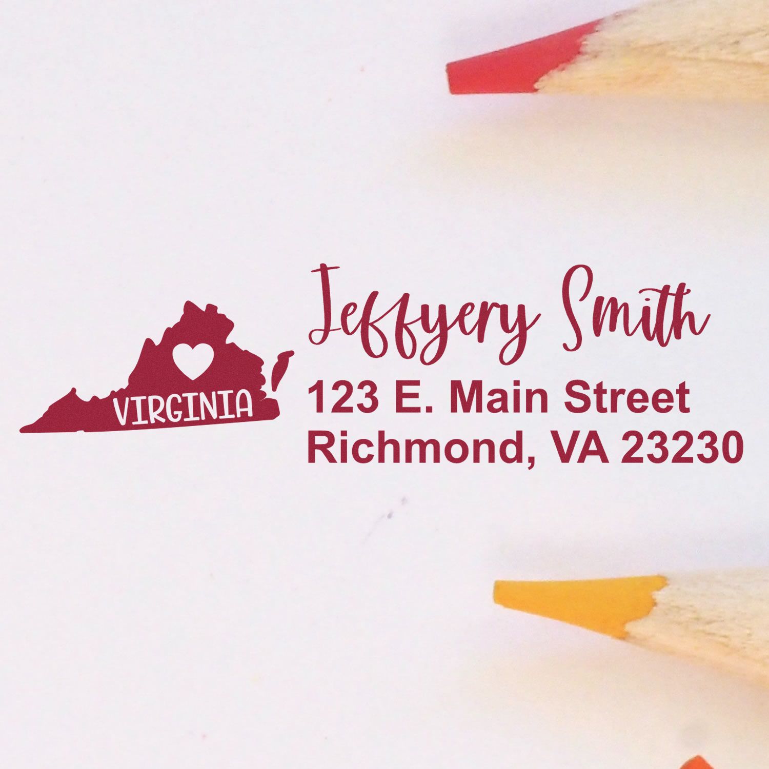 Slim Virginia Custom Address Stamp for Envelopes displayed on white paper with red and yellow pencils. Features a heart in Virginia state outline, personalized with name and address in elegant font.