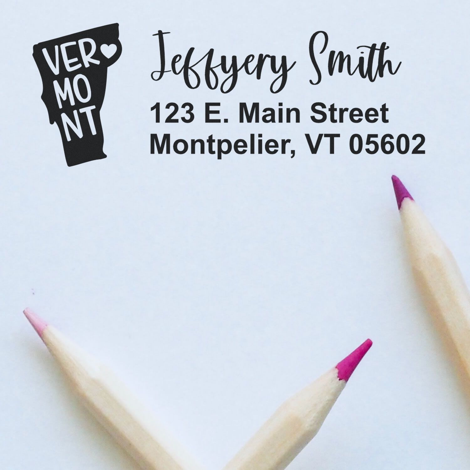 State Love of Vermont Custom Address Stamp Self-Inking displayed on paper with Vermont design, featuring the name Jeffery Smith and Montpelier address, surrounded by two pink-tipped pencils.