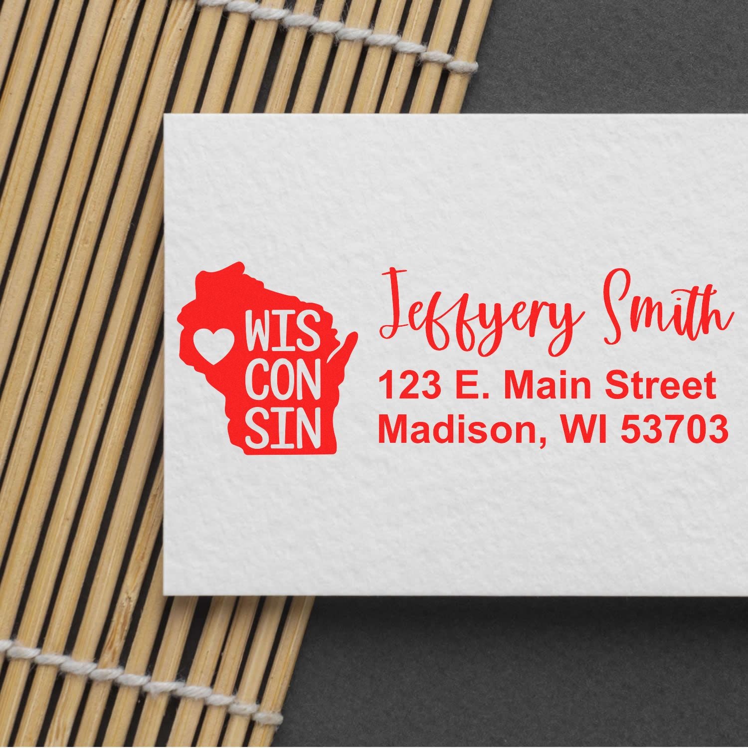 Slim Wisconsin Custom Address Stamp for Envelopes displayed on a white card with red text and a Wisconsin state outline, featuring a heart symbol. Perfect for personalizing mail with style.