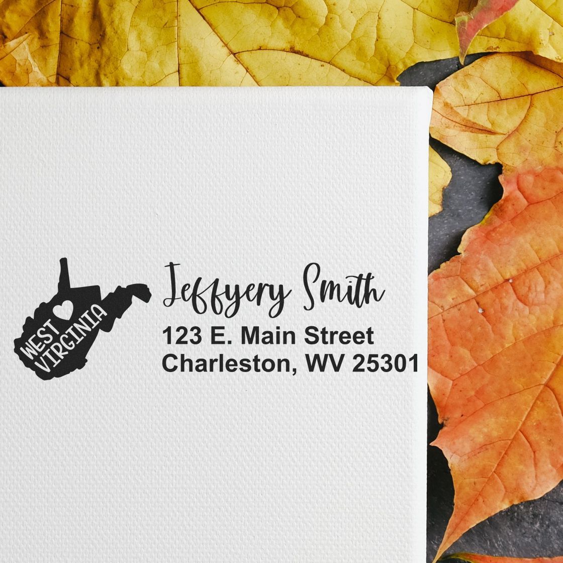 West Virginia State Love Personalized Address Stamp on white paper, featuring a map outline with heart, surrounded by autumn leaves. Text reads Jeffery Smith, 123 E. Main Street, Charleston, WV 25301 .