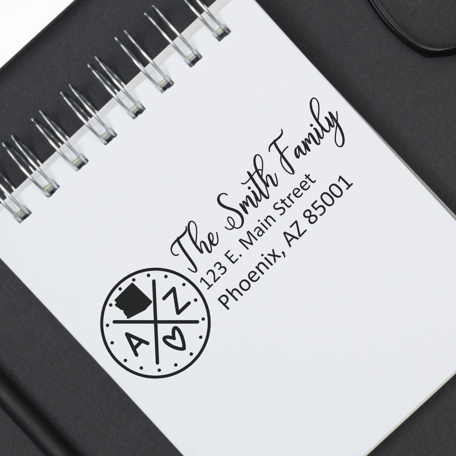 Arizona State Pride Customized Address Stamp on a notepad, featuring a circular design with AZ and a heart. Displays The Smith Family, 123 E. Main Street, Phoenix, AZ 85001 in elegant script.