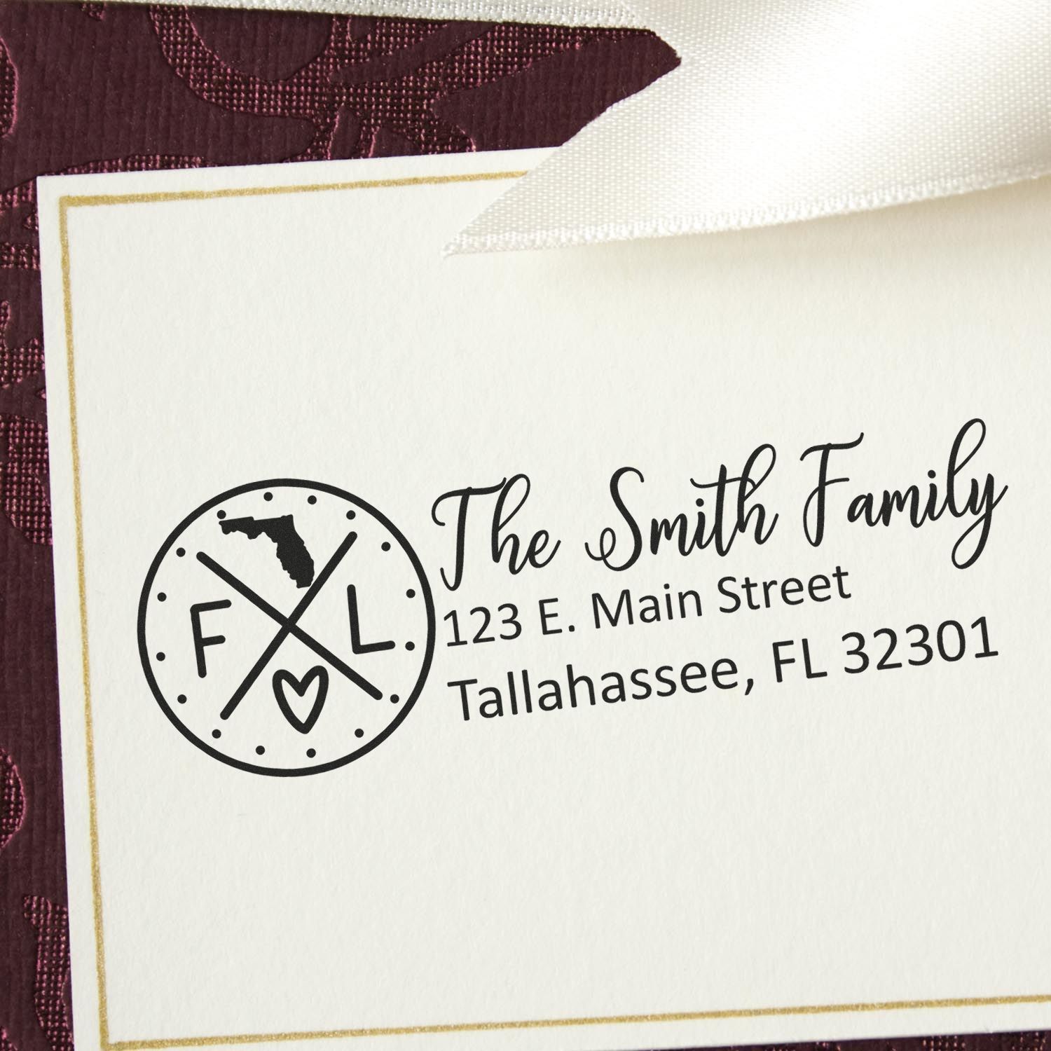 Florida State Pride Customized Address Stamp on an envelope, featuring a circular design with FL and a heart, alongside personalized address details for the Smith Family in Tallahassee, FL.