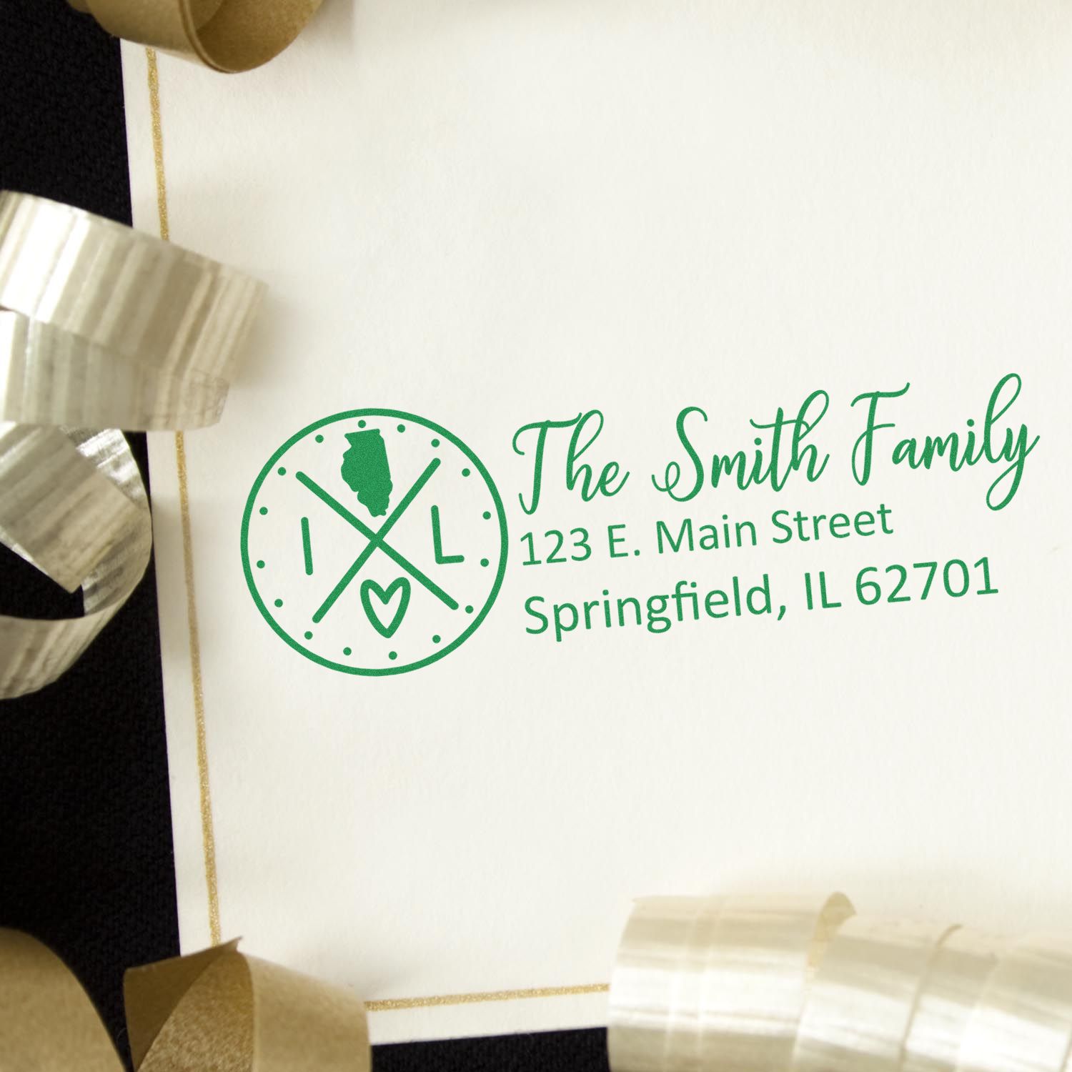 PSI Pre-Inked Illinois State Pride Customized Address Stamp on an envelope with gold ribbon. Features a green Illinois design and personalized address for the Smith Family in Springfield, IL.