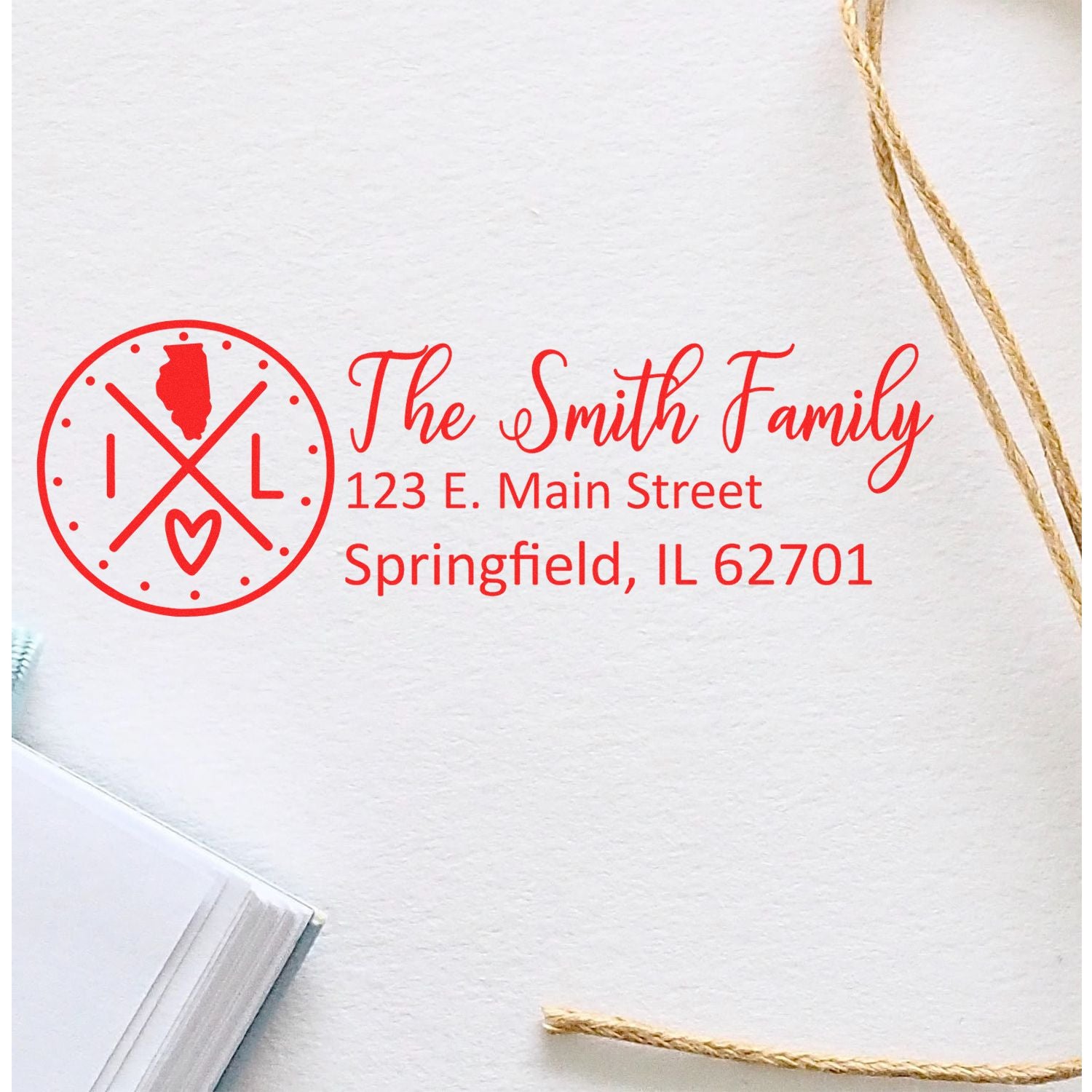 Slim Illinois Customized Pre-Inked Address Stamp in red ink on white paper, featuring a circular design with an Illinois outline, personalized with The Smith Family and Springfield address.