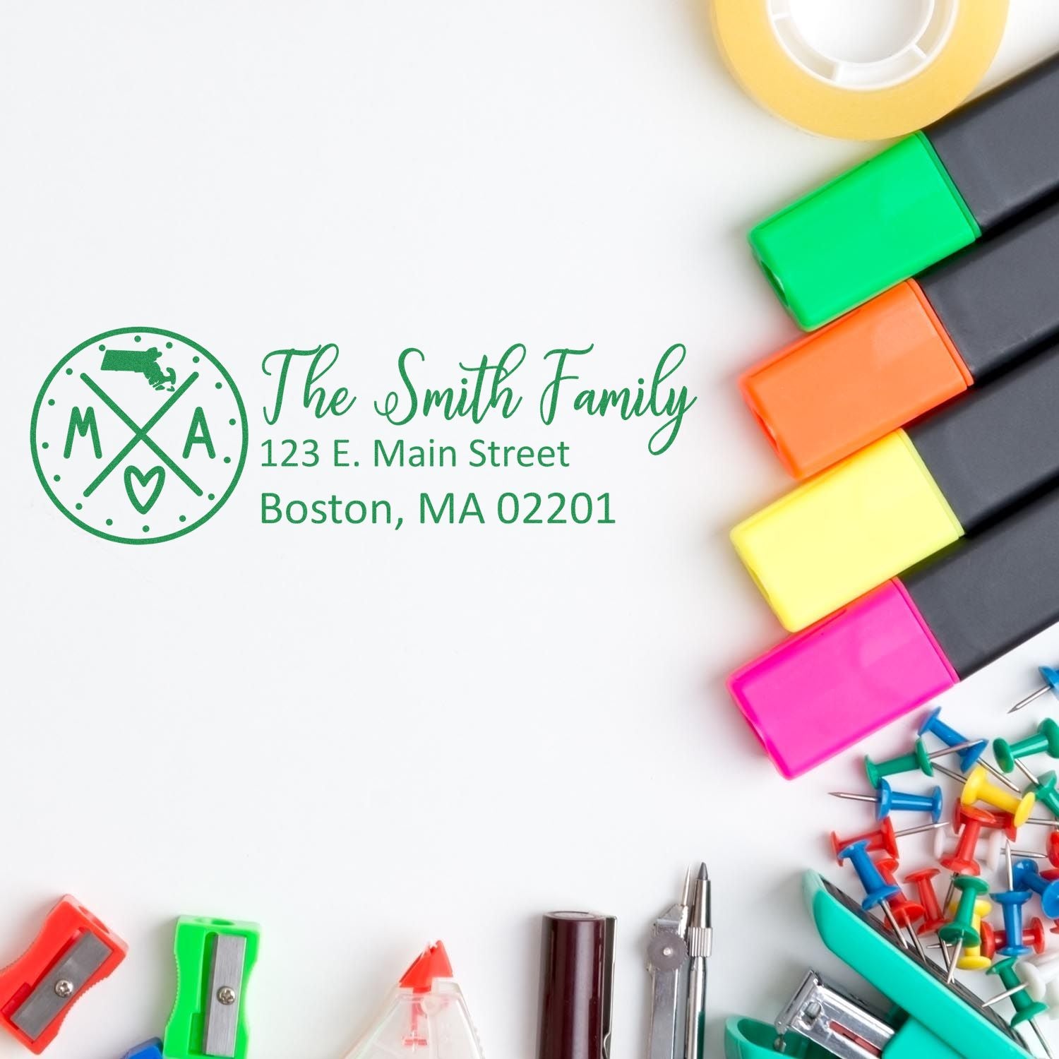 Massachusetts State Pride Customized Address Stamp featuring The Smith Family with an address, surrounded by colorful office supplies like markers, push pins, and tape on a white background.