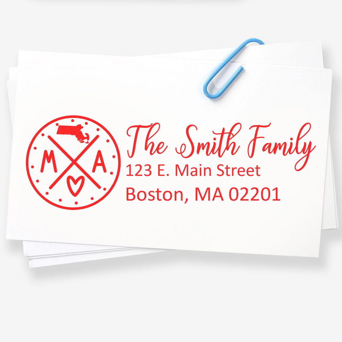 Massachusetts State Pride Customized Address Stamp featuring a red design with state outline, initials, and heart. Displays The Smith Family, 123 E. Main Street, Boston, MA 02201 on white paper.