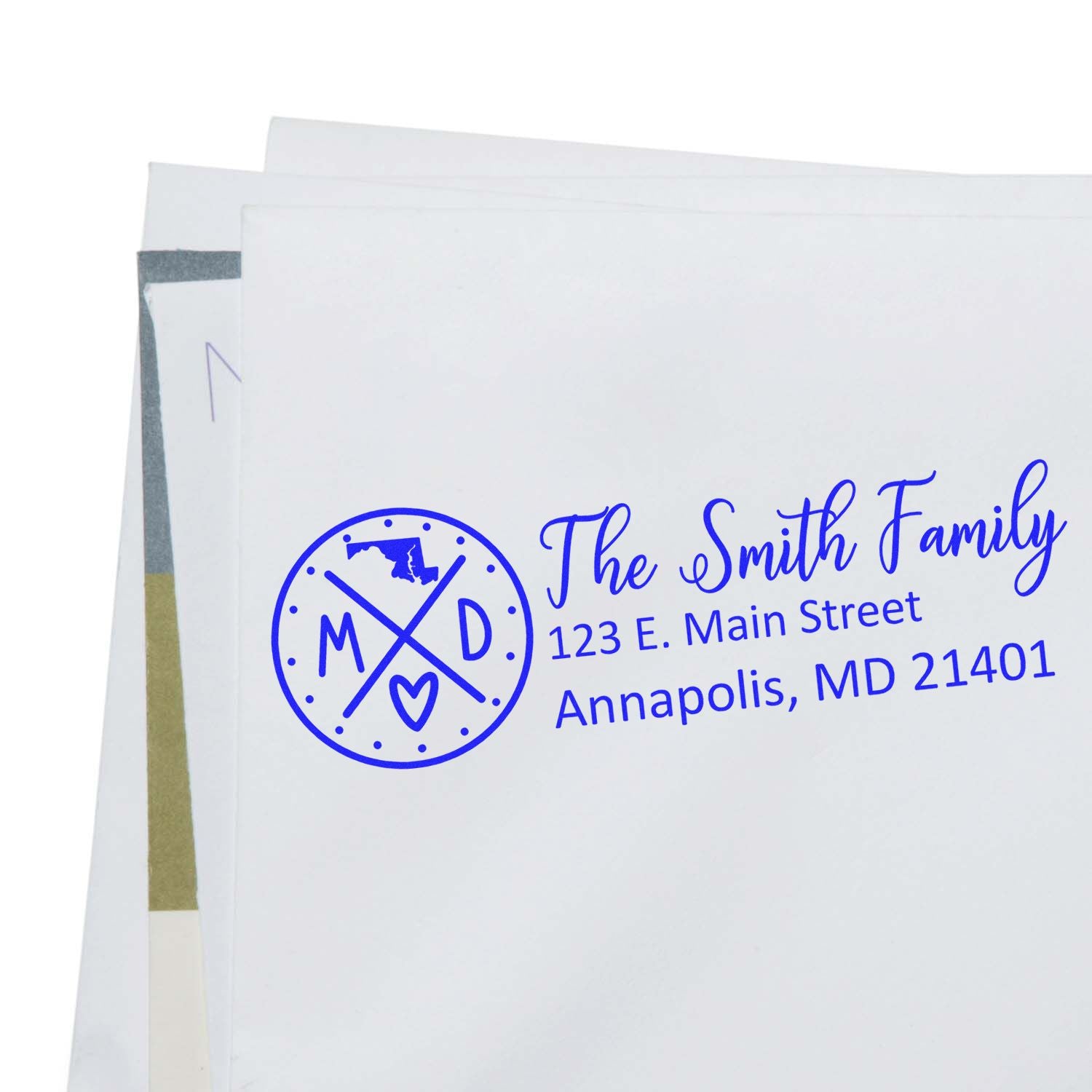 Self-Inking State Love of Maryland Custom Address Stamp on a white envelope, featuring a blue design with MD and a heart, personalized with The Smith Family and an Annapolis address.