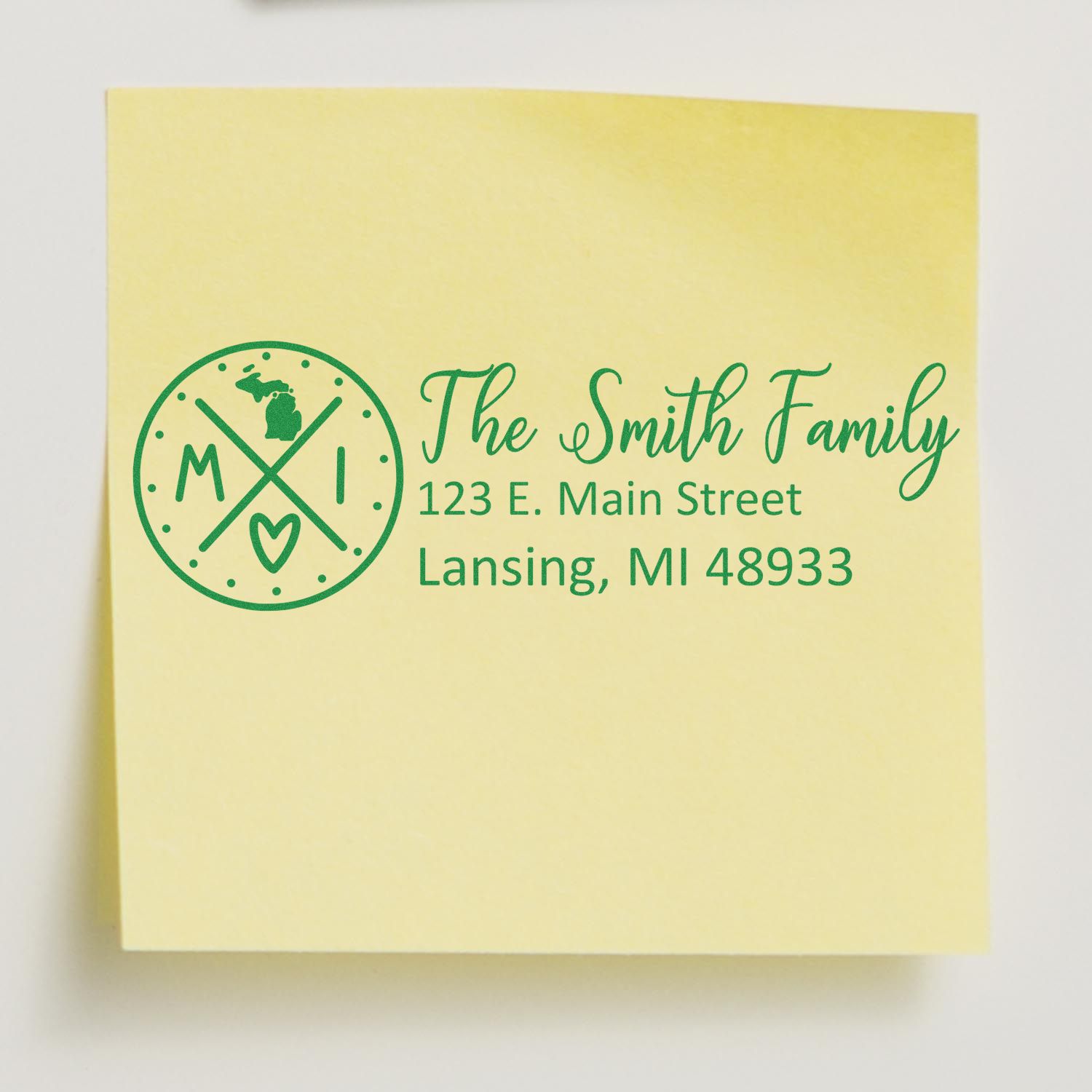 Self-Inking State Love of Michigan Custom Address Stamp on a yellow note, featuring The Smith Family and a Michigan-themed design with address in green ink.