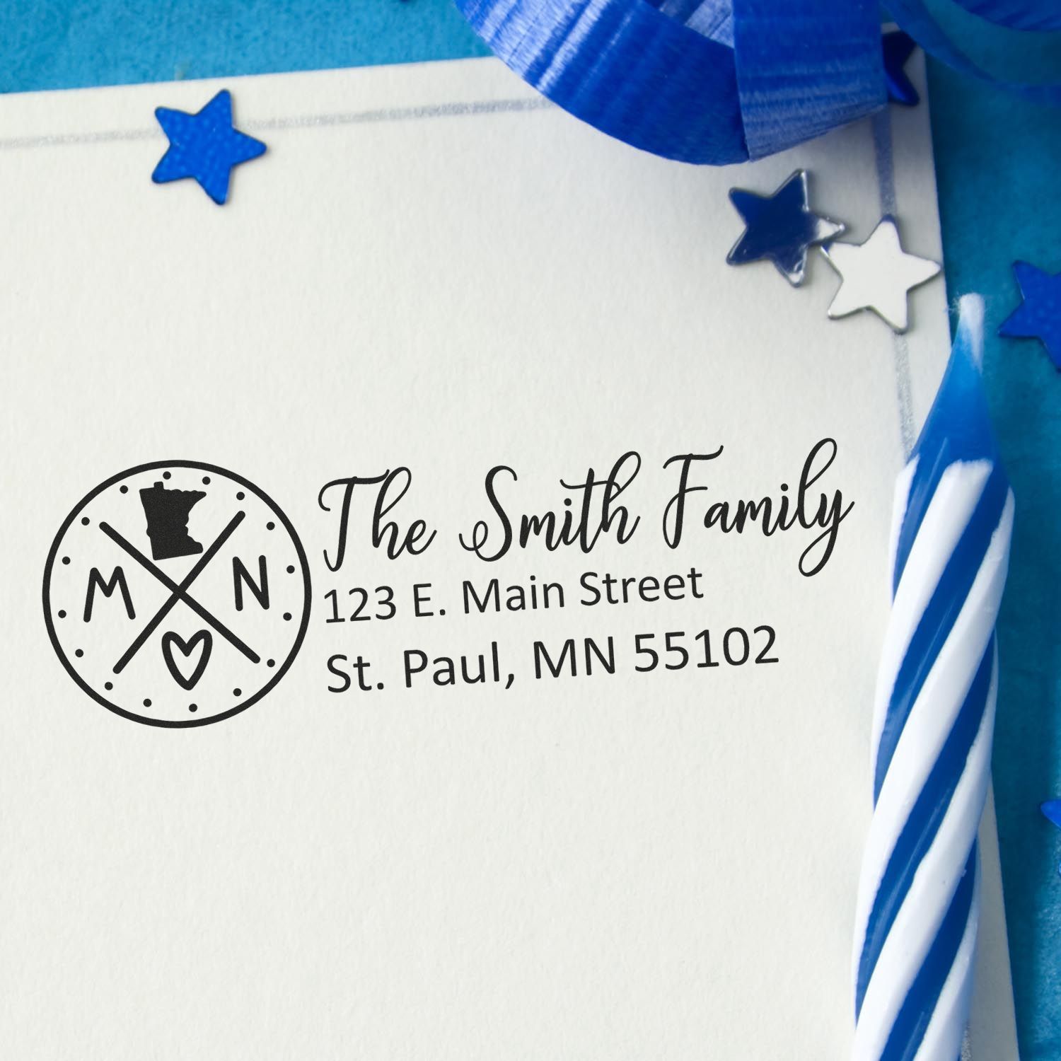 Minnesota State Pride Customized Address Stamp on an envelope with blue stars and a striped candle, featuring a personalized family name and address in elegant script.