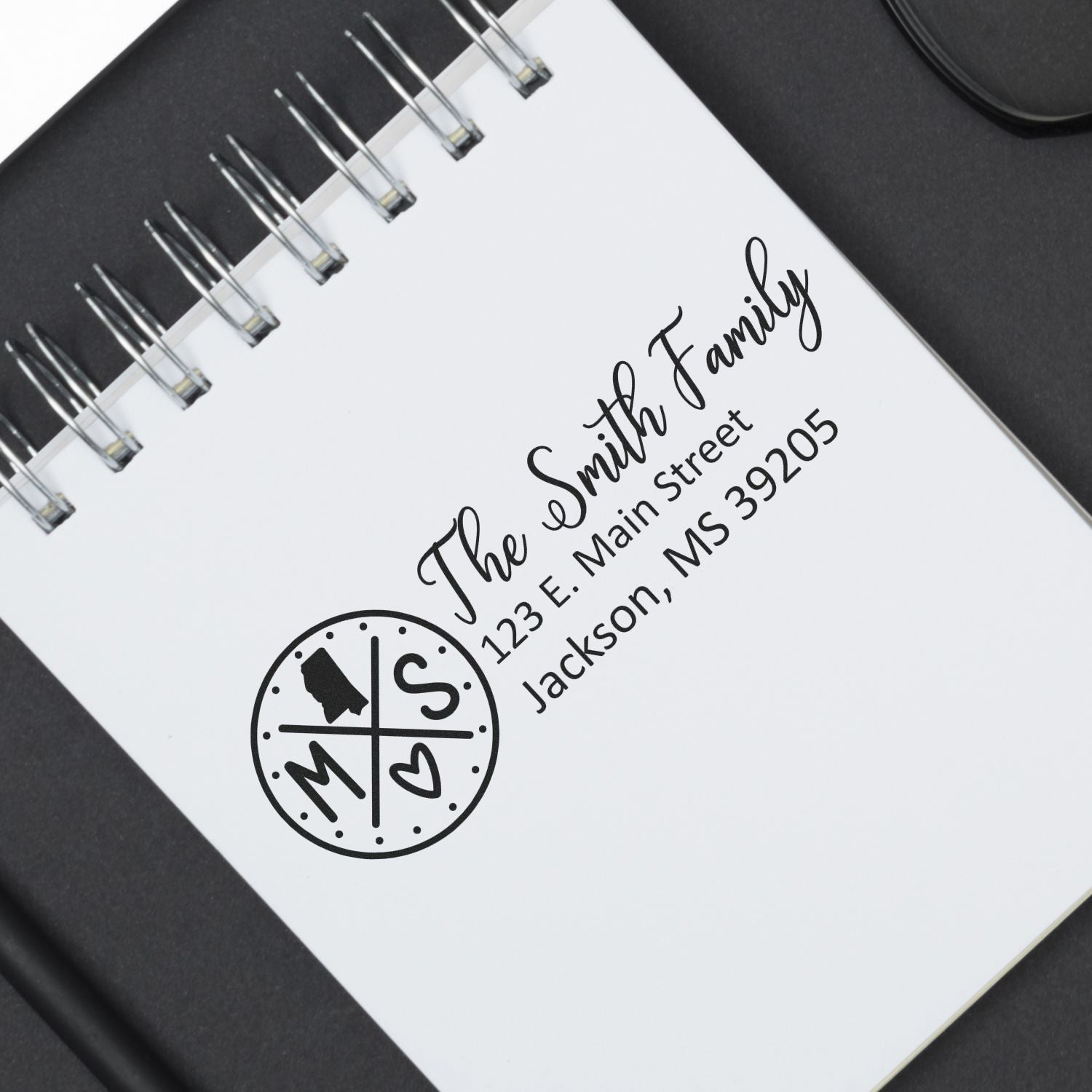 Mississippi State Pride Customized Address Stamp on a notepad, featuring a personalized family name and address with a stylish state-themed design.