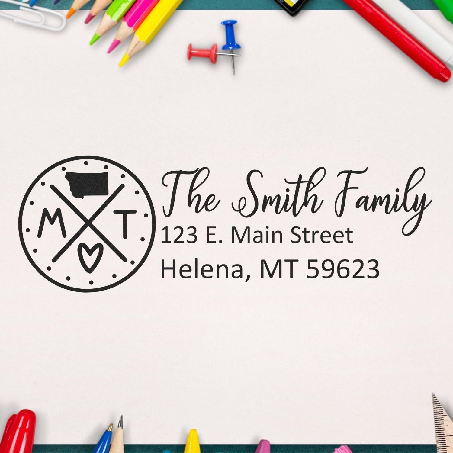 Montana State Pride Customized Address Stamp featuring a circular design with MT and a heart, personalized with The Smith Family and an address. Surrounded by colorful stationery items.