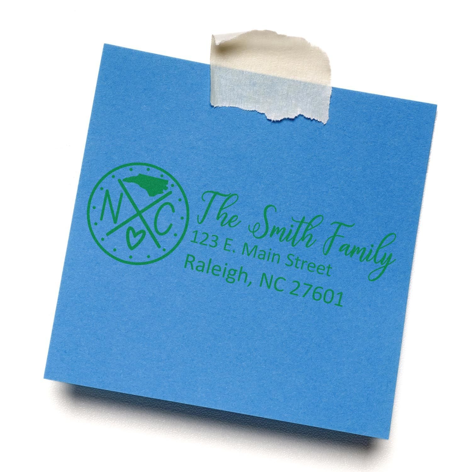 Blue paper with a green North Carolina State Pride Customized Address Stamp, featuring The Smith Family and an address in Raleigh, NC.