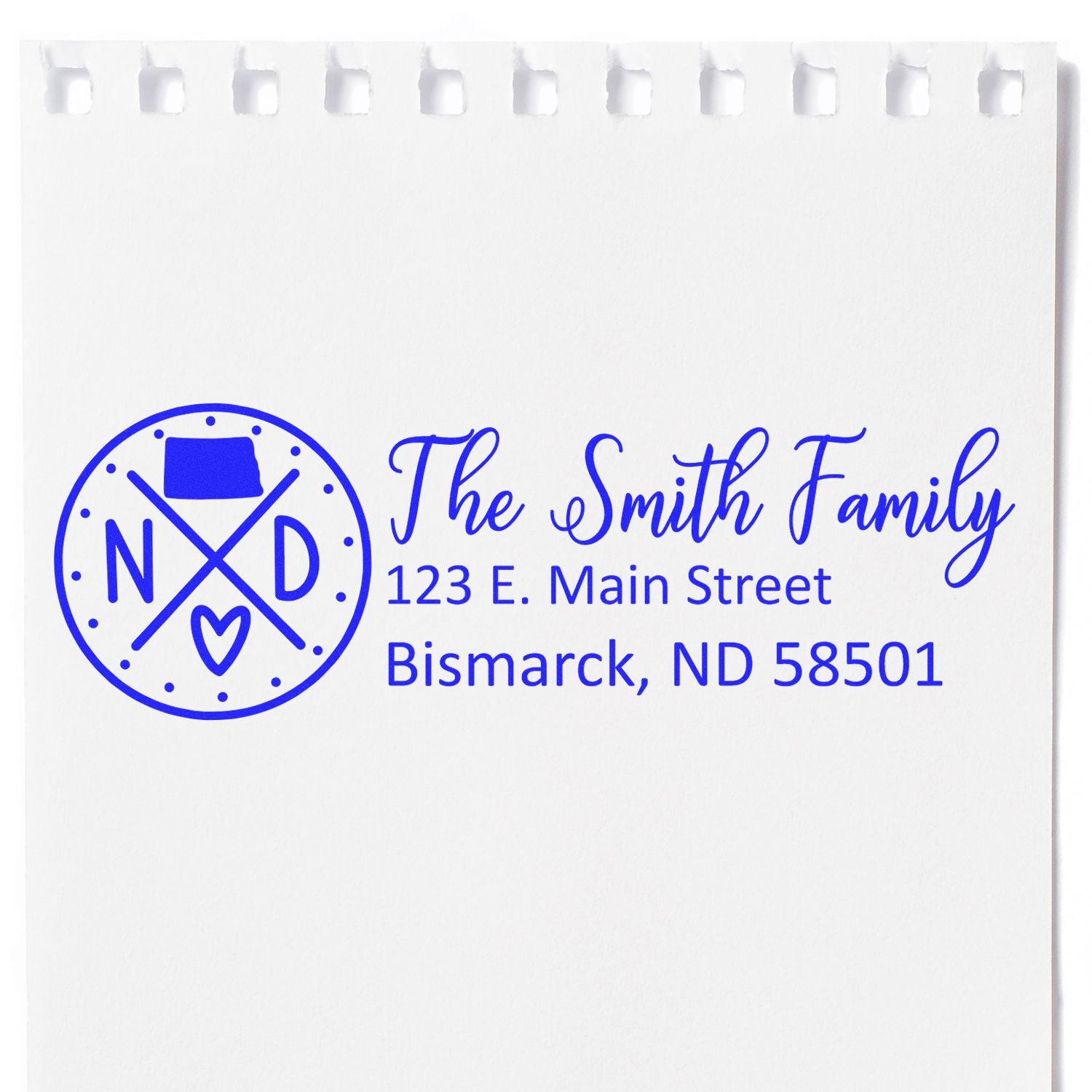 PSI Pre-Inked North Dakota State Pride Customized Address Stamp featuring a blue design with ND and a heart, personalized with The Smith Family and an address in Bismarck, ND on white paper.