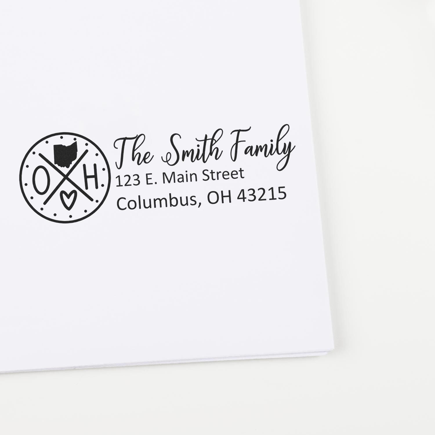 Self-Inking State Love of Ohio Custom Address Stamp on white paper, featuring The Smith Family and an Ohio-themed design with address: 123 E. Main Street, Columbus, OH 43215.