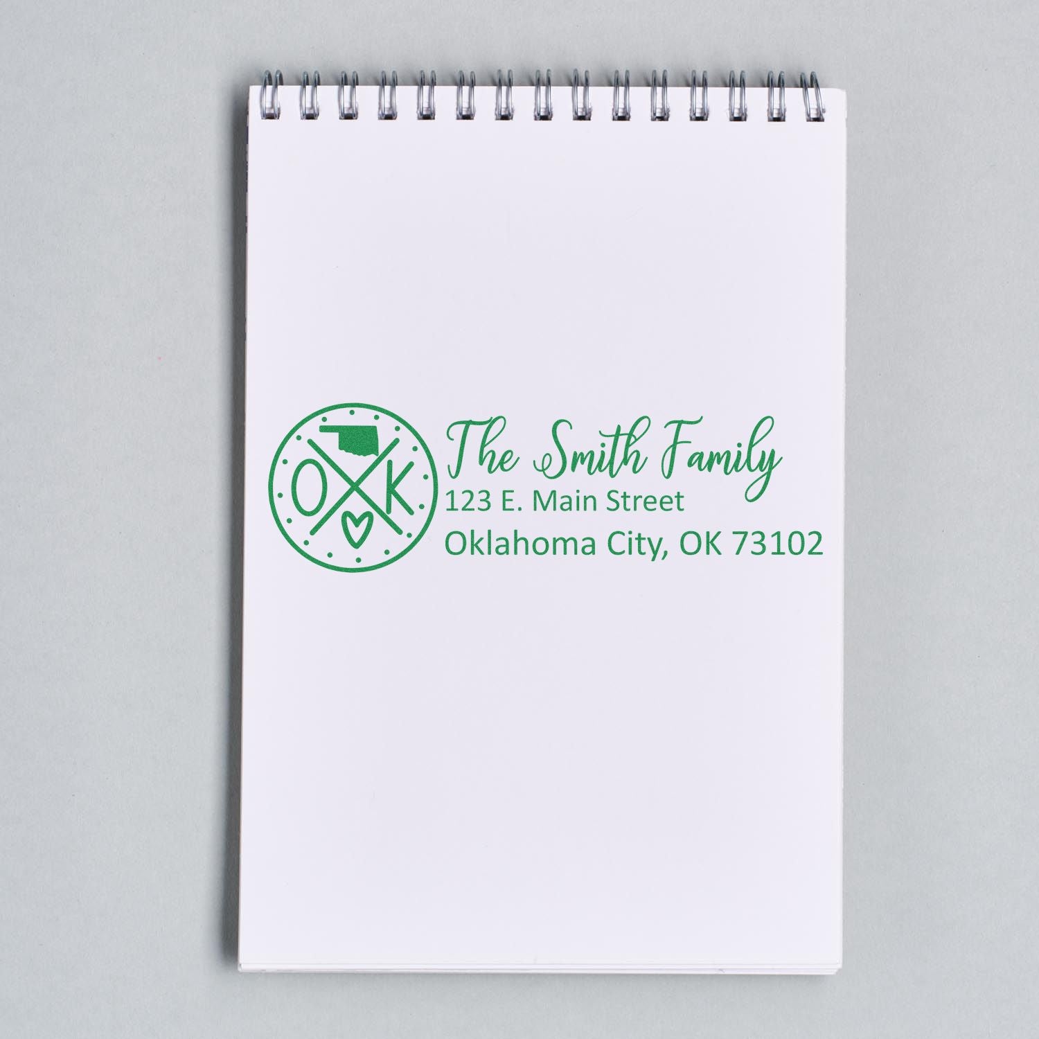 Oklahoma State Pride Customized Address Stamp on a notepad, featuring a green design with a state outline and heart, personalized with The Smith Family and an Oklahoma City address.