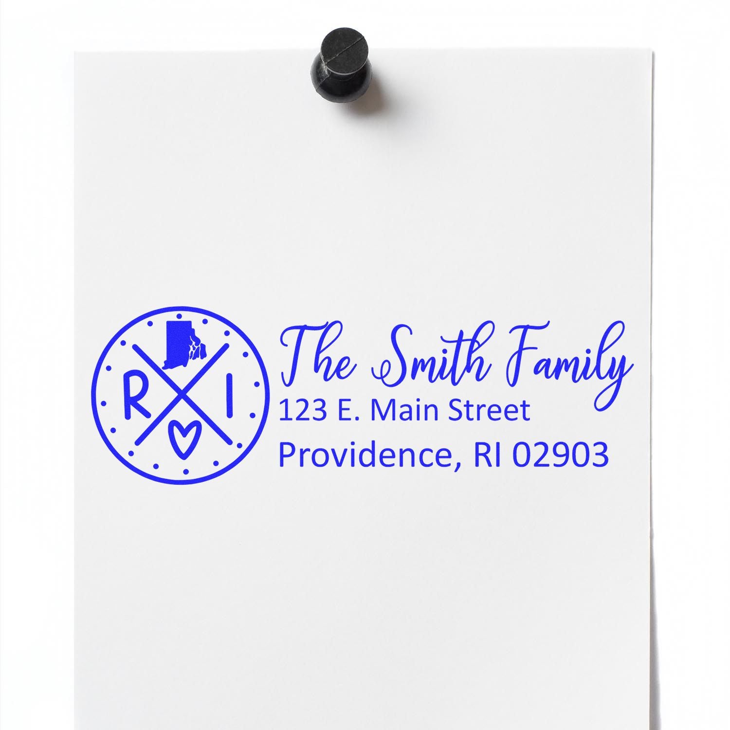 Self-Inking State Love of Rhode Island Custom Address Stamp on white paper, featuring a blue design with RI and a heart, personalized with The Smith Family, 123 E. Main Street, Providence, RI 02903.