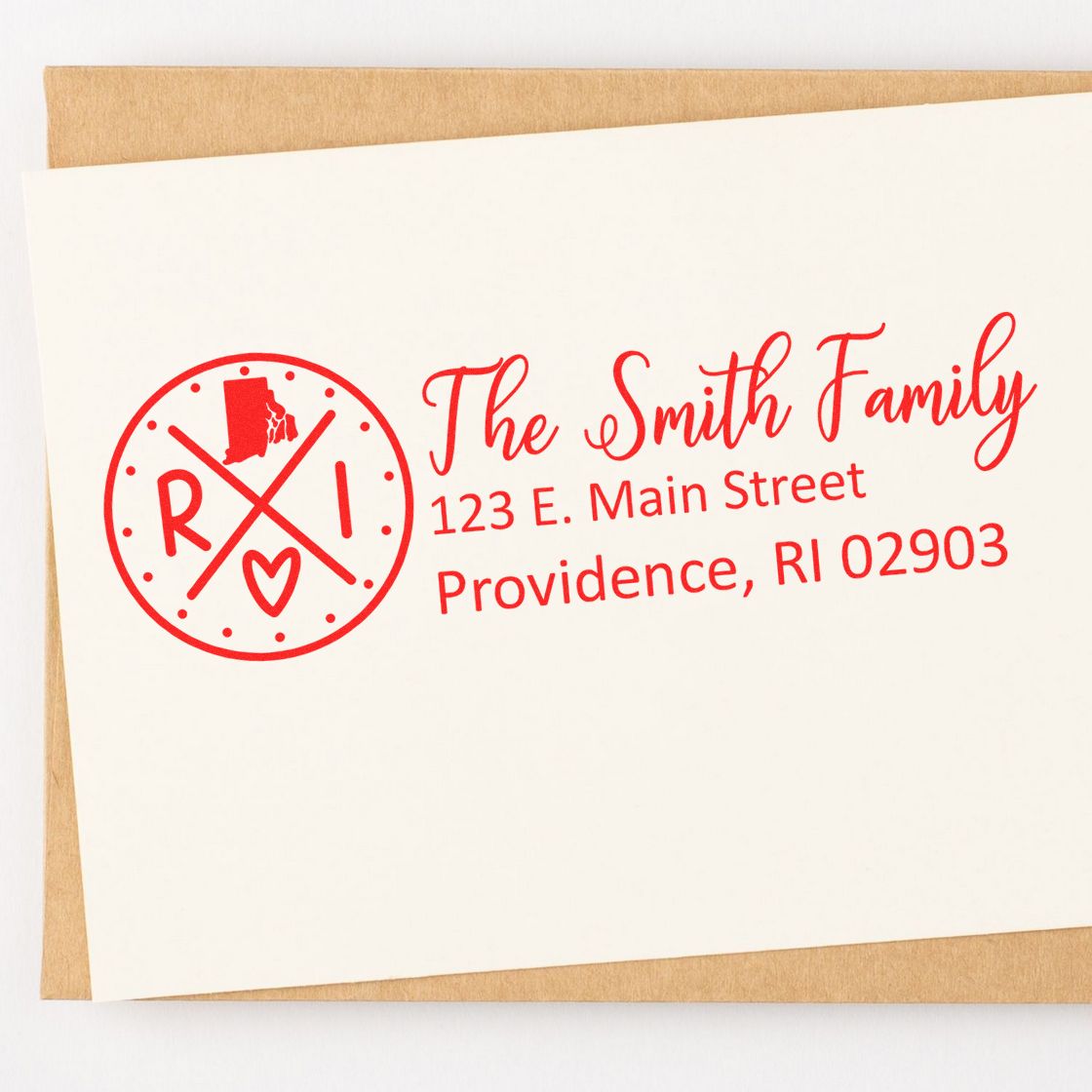 Slim Rhode Island Customized Pre-Inked Address Stamp in red ink on an envelope, featuring a circular design with RI and a heart, personalized with The Smith Family and address details.