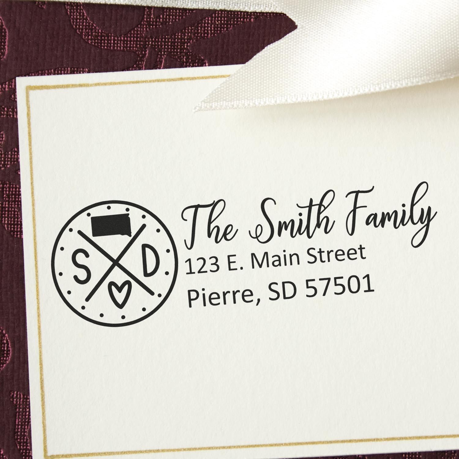 PSI Pre-Inked South Dakota State Pride Customized Address Stamp on an envelope, featuring a circular SD design with a heart and crossed lines, personalized with 'The Smith Family' address.