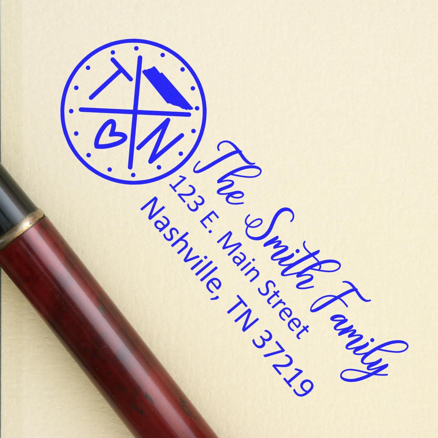 PSI Pre-Inked Tennessee State Pride Customized Address Stamp on paper with a pen nearby, featuring a circular TN design and personalized address in blue ink.