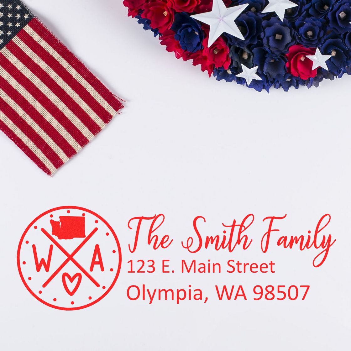 Washington State Pride Customized Address Stamp featuring a red design with a state outline, heart, and arrows. Displayed with a patriotic theme, including an American flag and red, white, and blue flowers.