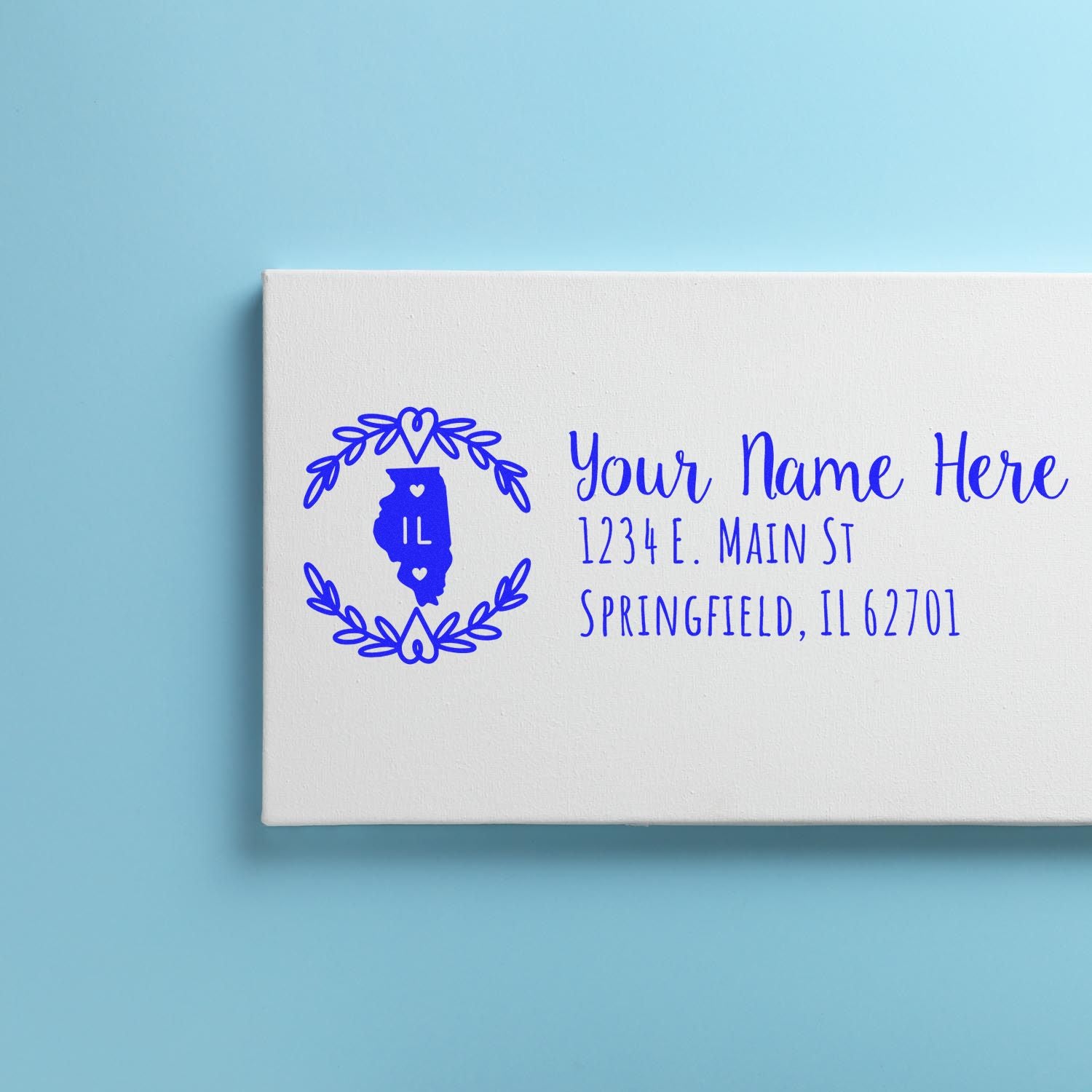 Illinois State Custom Return Address Stamp on a white canvas against a blue background, featuring a blue outline of Illinois with space for personalized name and address.