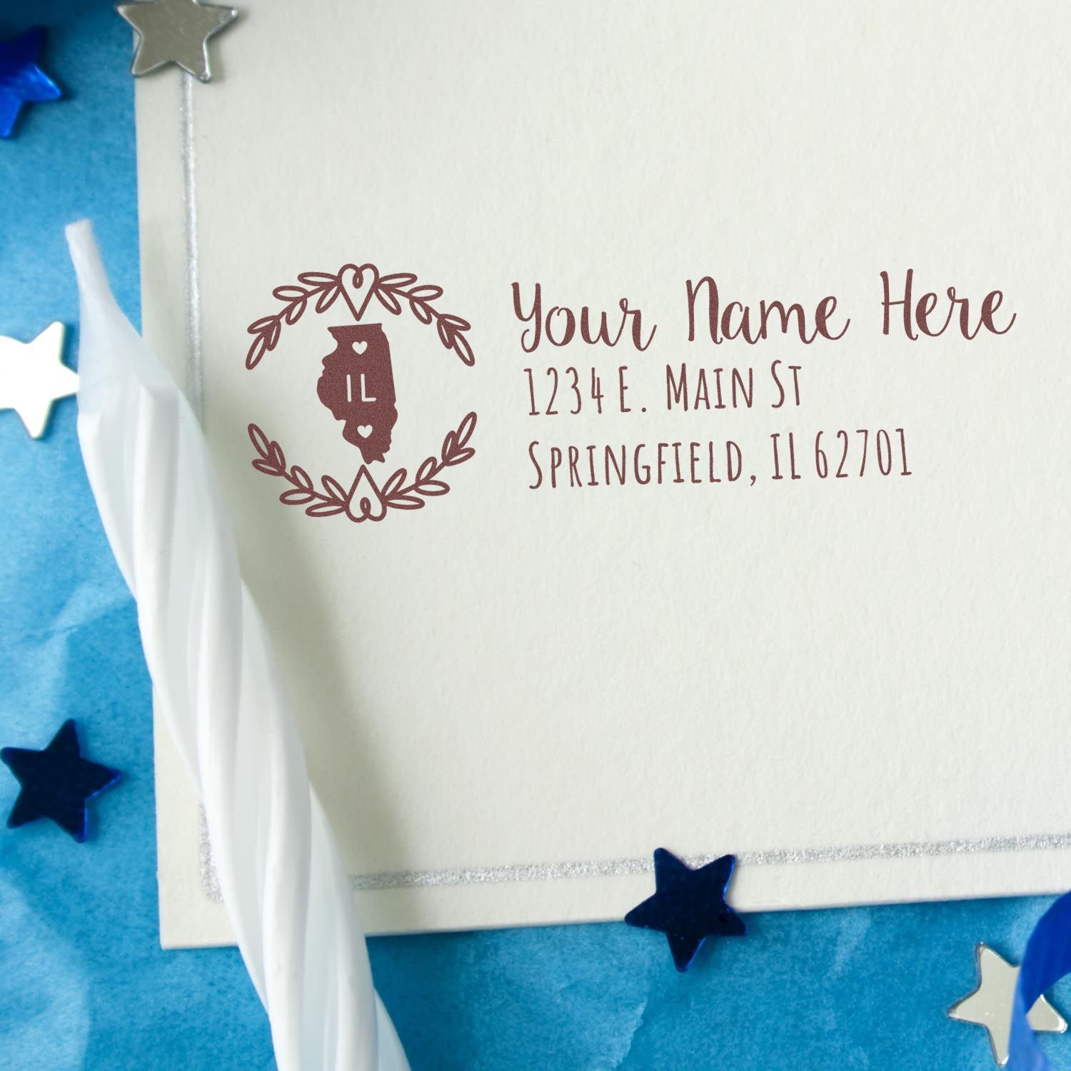 Illinois State Custom Return Address Stamp on an envelope, featuring a decorative state outline and personalized address in elegant font, surrounded by festive stars and a white candle.