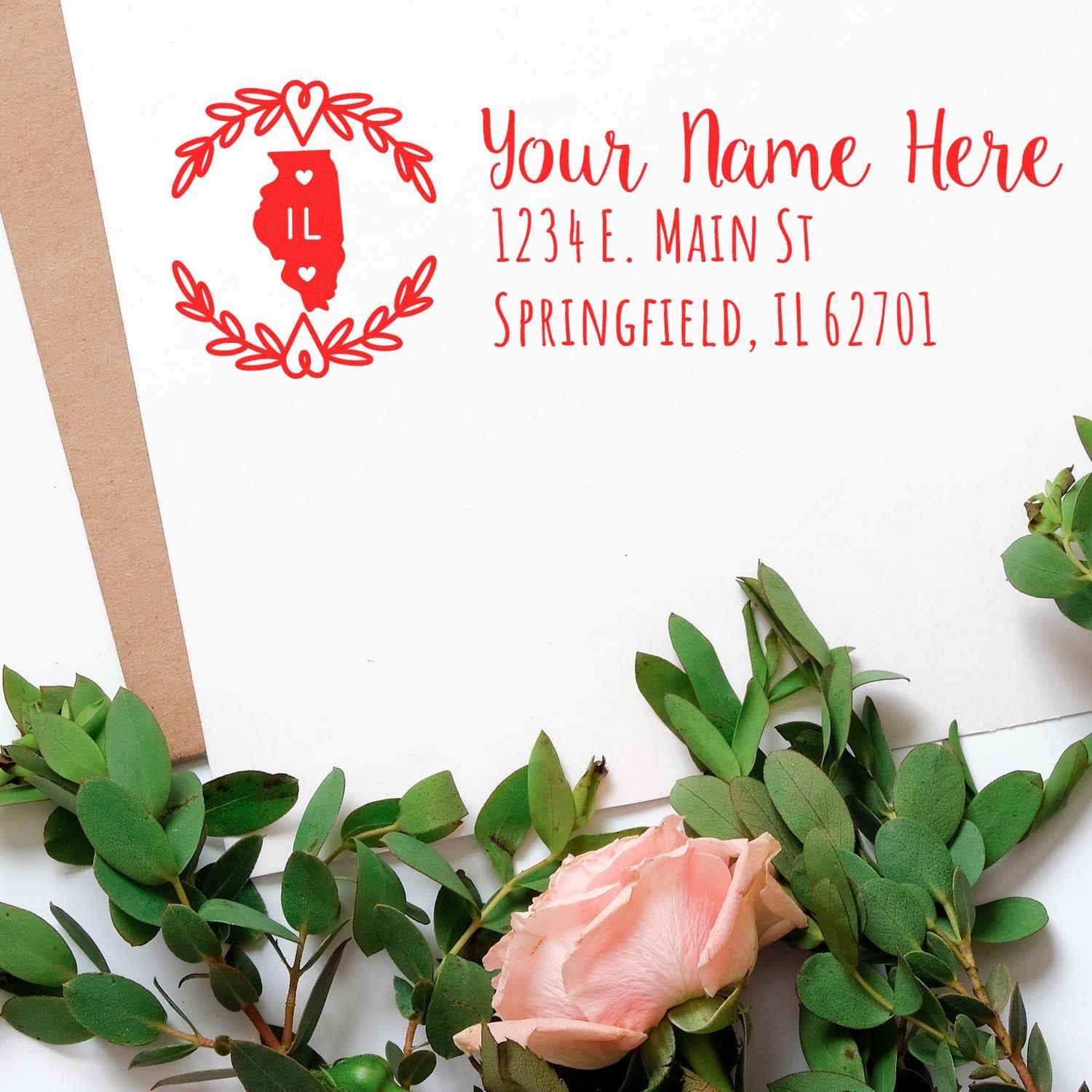 Slim Illinois Personalized Pre-Inked Address Stamp on an envelope with a floral design, featuring a red Illinois state outline and customizable text for name and address.