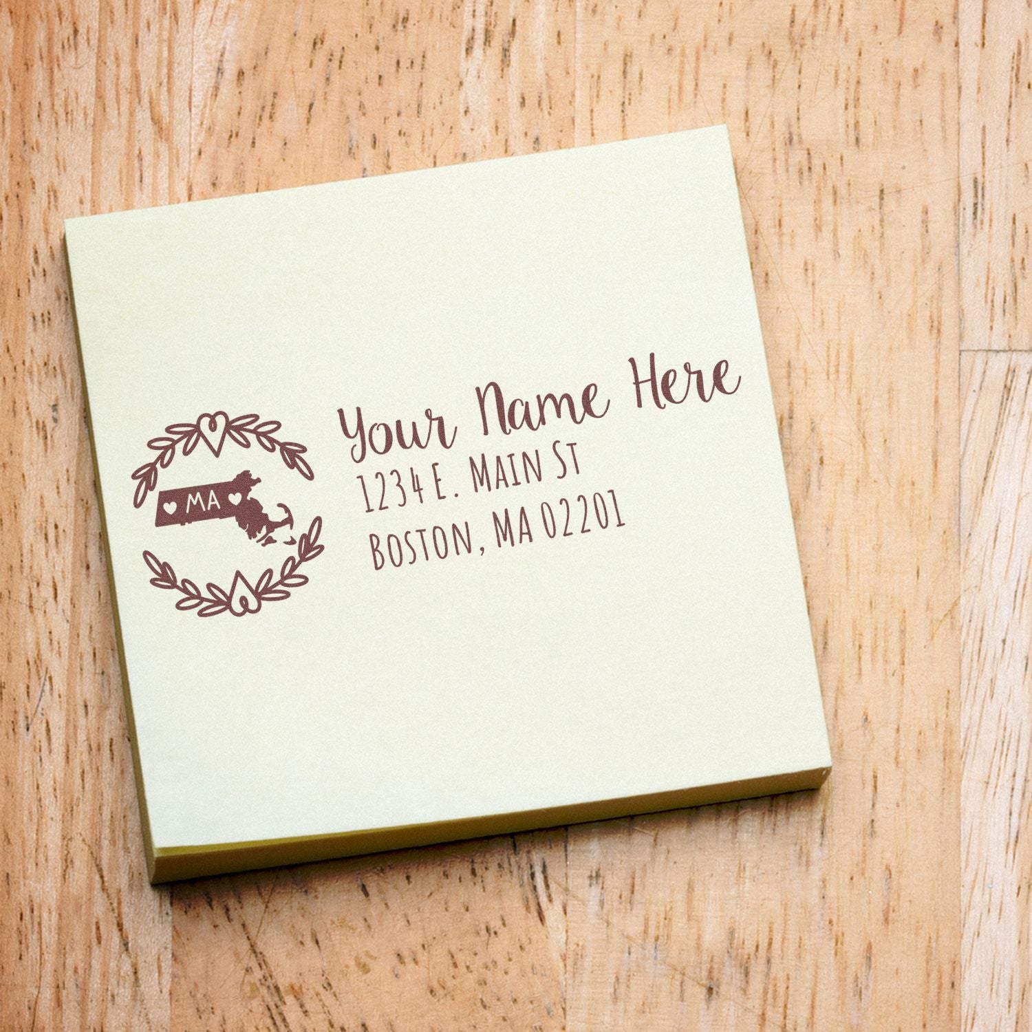 Massachusetts State Custom Return Address Stamp on a beige envelope, featuring a decorative state outline and personalized address in elegant script. Perfect for adding a personal touch to your mail.