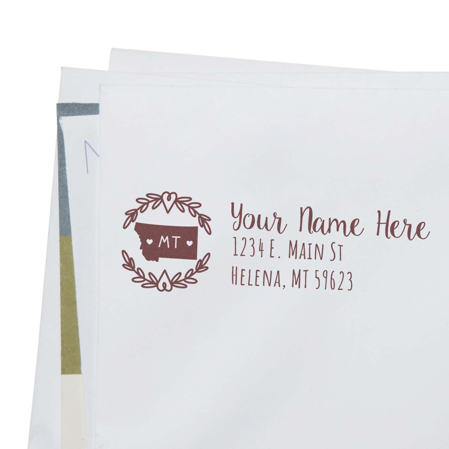 PSI Pre-Inked Montana State Customized Address Stamp on white envelope, featuring a decorative Montana state outline with hearts and personalized address text.