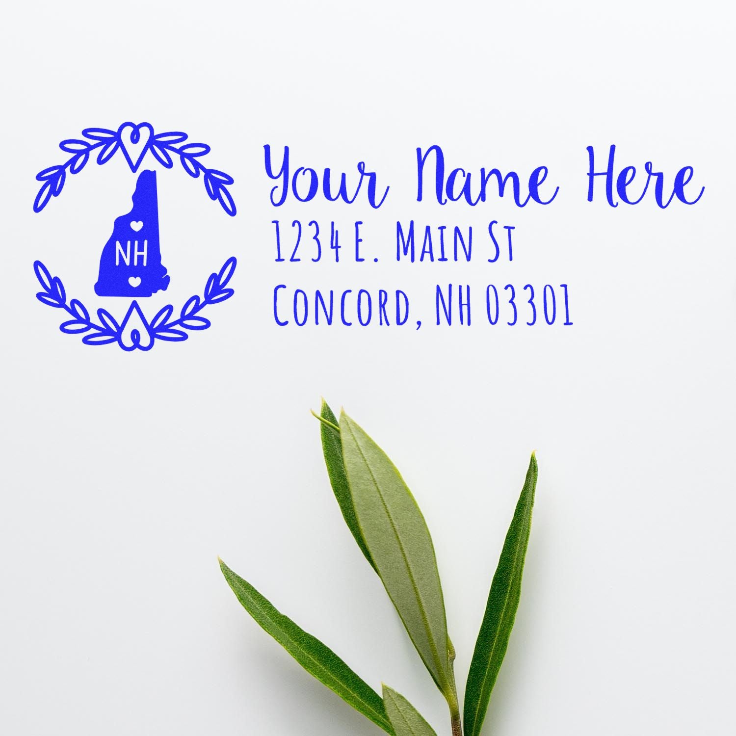 New Hampshire State Custom Return Address Stamp featuring a blue state outline with hearts and laurel design, personalized with name and address, displayed on a white background with green leaves.