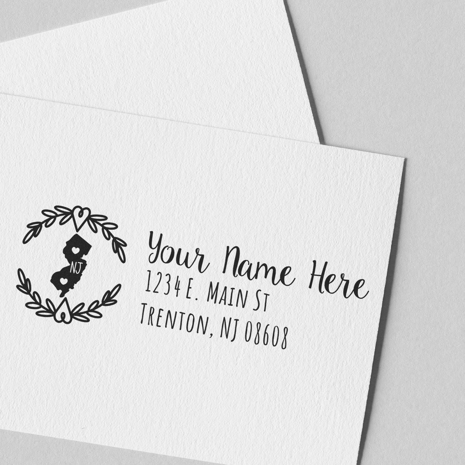 Slim New Jersey Personalized Pre-Inked Address Stamp on white envelope, featuring a heart design with NJ and sample address text in elegant font. Perfect for adding a personal touch to mail.