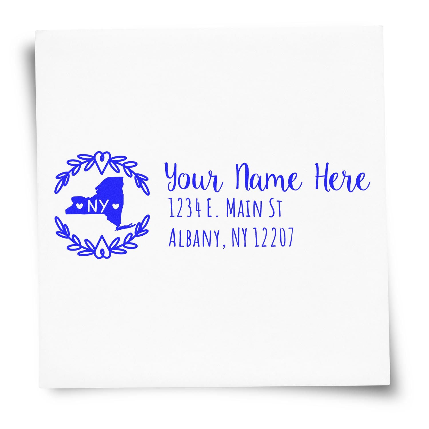 Slim New York Personalized Pre-Inked Address Stamp featuring a blue outline of New York with hearts, surrounded by a wreath, and customizable text for name and address on a white background.