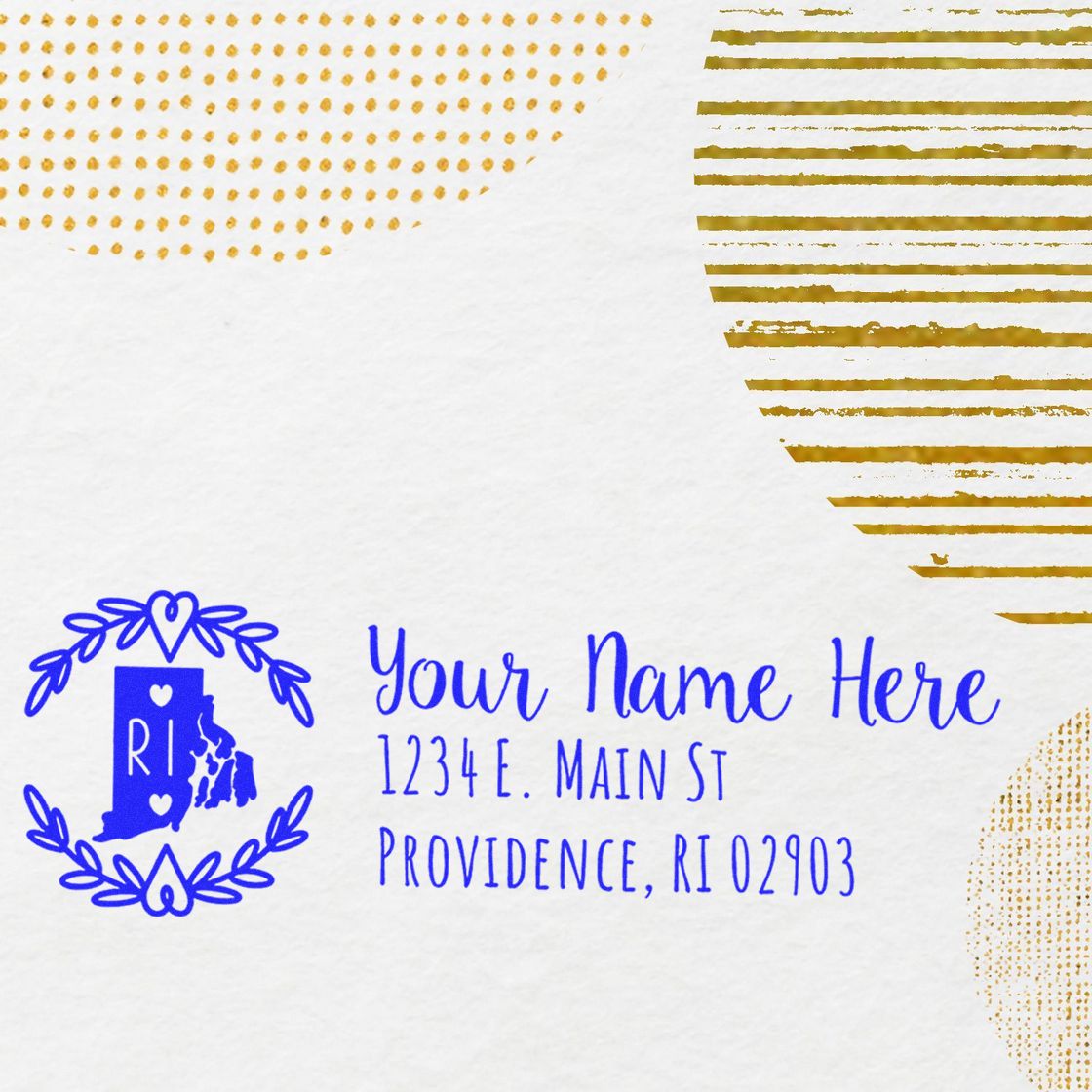 Slim Rhode Island Personalized Pre-Inked Address Stamp on white paper with blue text and decorative gold patterns, featuring a map outline and heart motif.