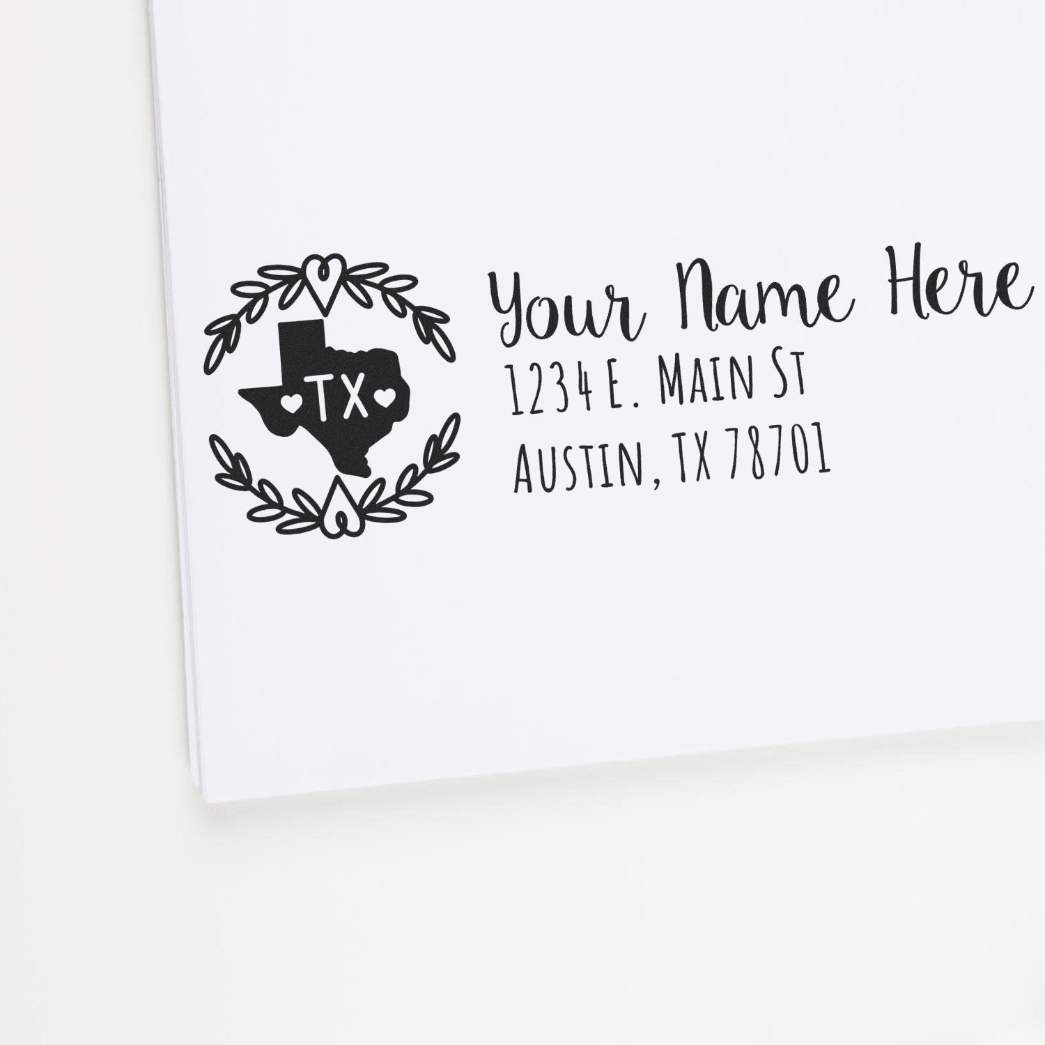 Slim Texas Personalized Pre-Inked Address Stamp on white paper, featuring a Texas outline with hearts and floral design, alongside customizable address text in elegant font.