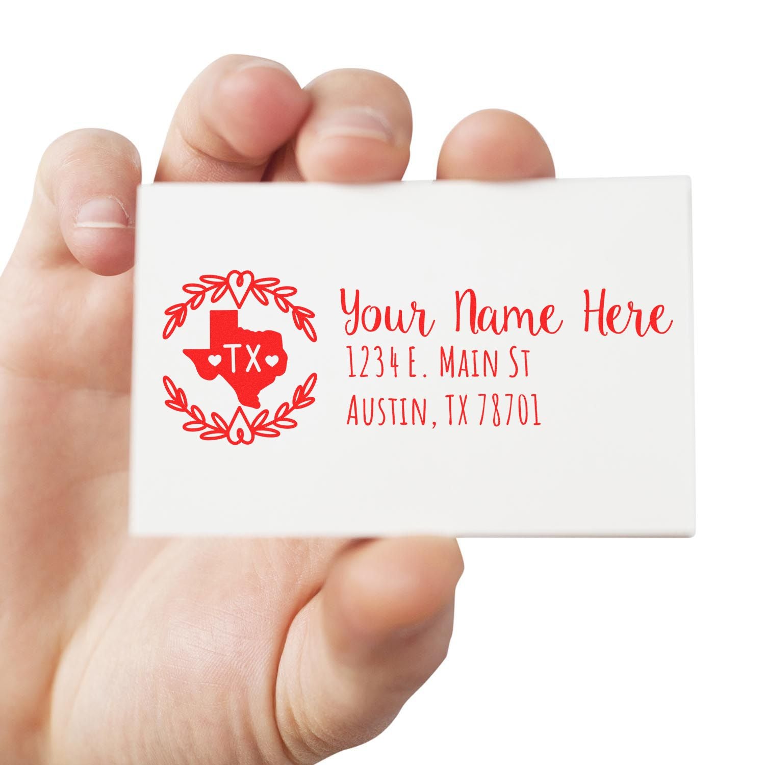 Hand holding a card featuring the Texas State Custom Return Address Stamp in red, with a heart design and sample address text. Perfect for personalizing mail with a Texas-themed touch.