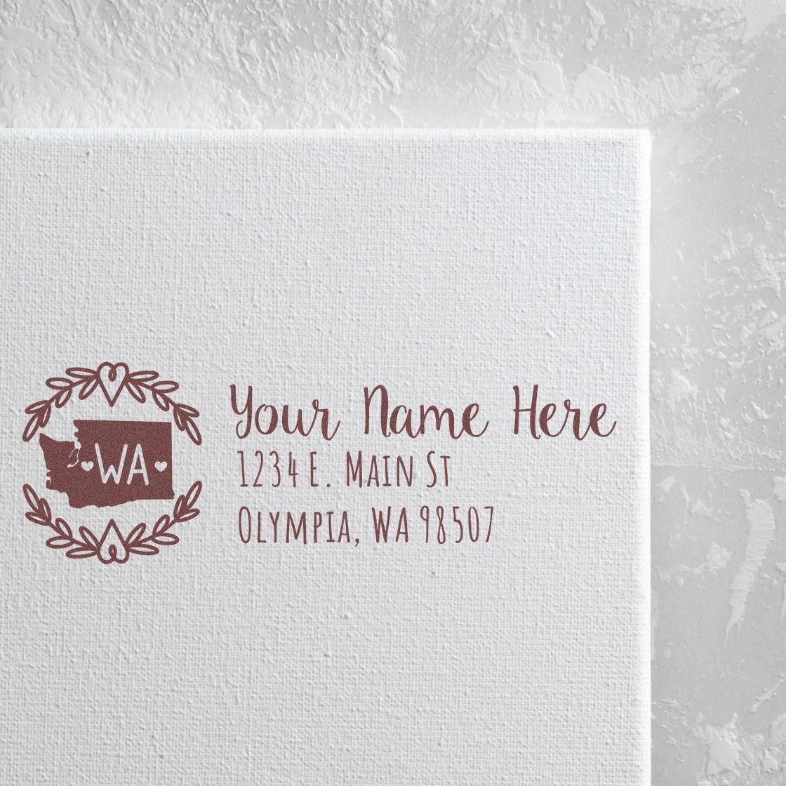 Self-Inking State Wreath of Washington Address Stamp on white paper, featuring a decorative WA state outline with floral wreath and customizable address text in elegant font.