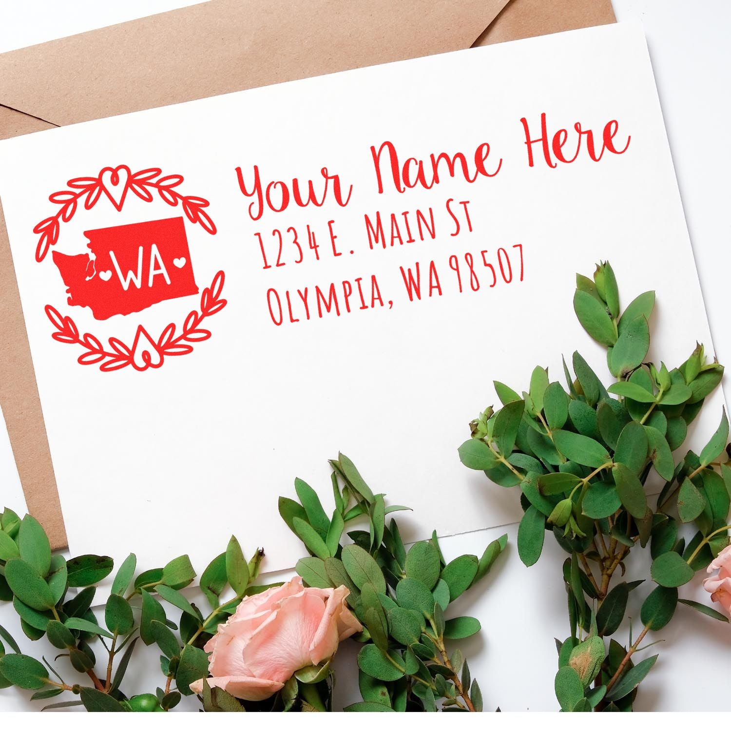 Self-Inking State Wreath of Washington Address Stamp on an envelope with a floral design, featuring a red state outline and address text.